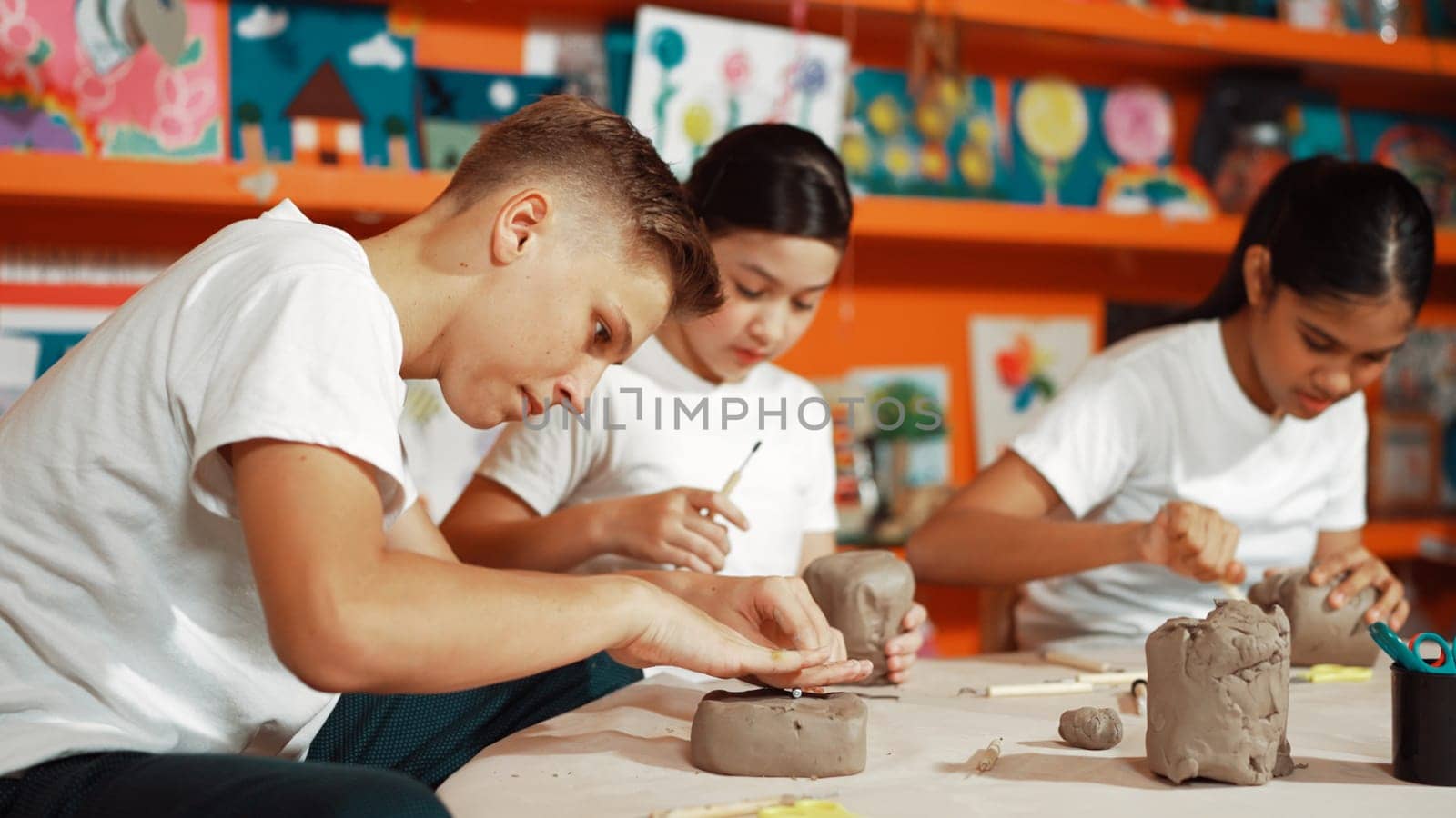 Group of happy smart diverse student working with clay at workshop. Edification. by biancoblue