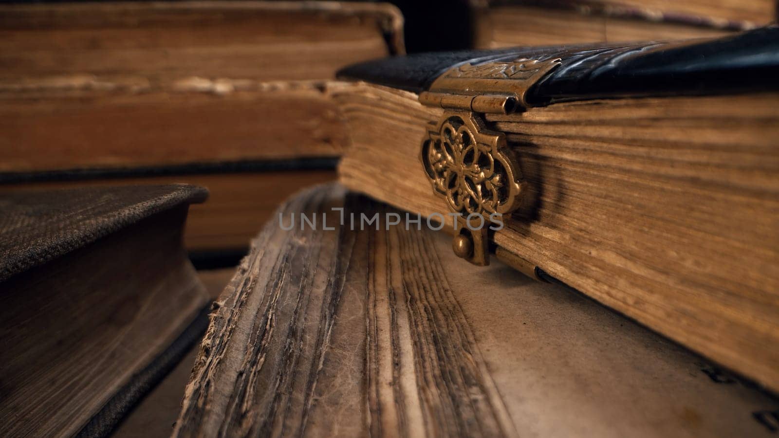 Macro view of saved medieval books with ancient writings. Religious literature, archival manuscripts, rare collection tomes, artifacts. High quality
