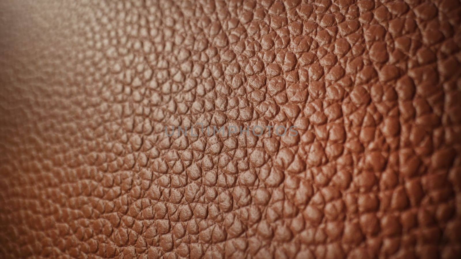 Extreme macro genuine brown leather background, high quality grained texture. Soft pattern surface of luxury bag. Animal skin material, handmade fashion accessories.