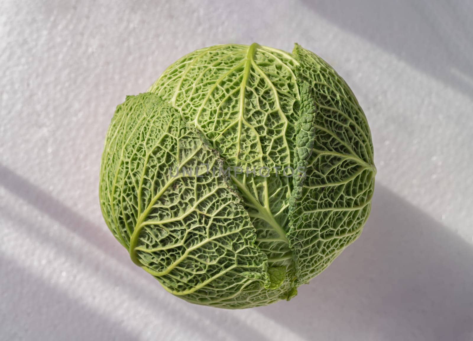 One fresh savoy cabbage isolated on White background. Whole head of organic savoy cabbage, Green vegetable, Space for text, Selective focus.