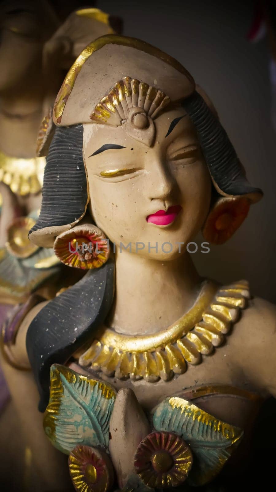 Beautiful artistic statue of a Balinese or javanese dancer used as garden decoration, javanese gnome indonesia asian garden statue