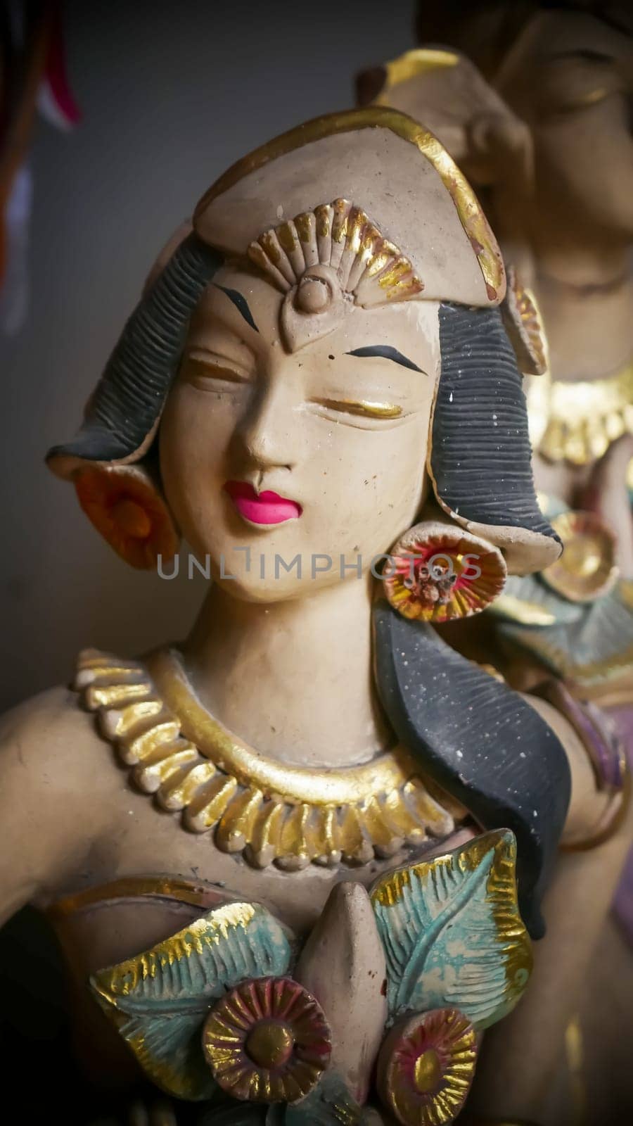 Beautiful artistic statue of a Balinese or javanese dancer used as garden decoration, javanese gnome indonesia asian garden statue