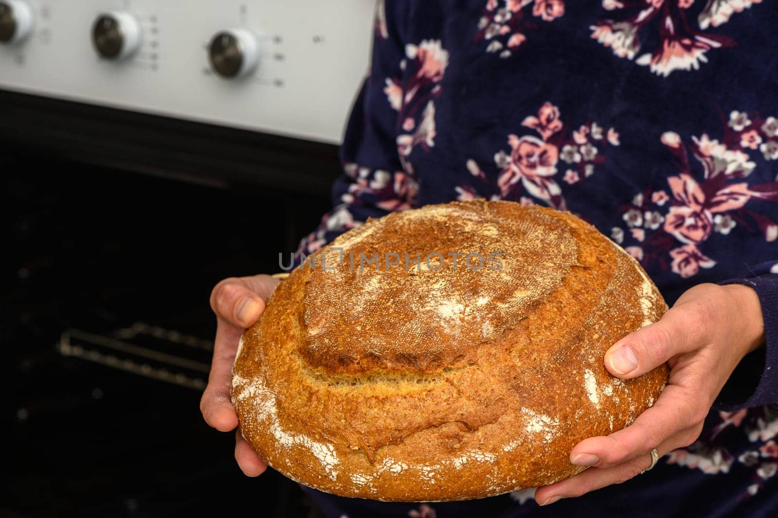 appetizing homemade whole grain bread in the hands of a woman 7