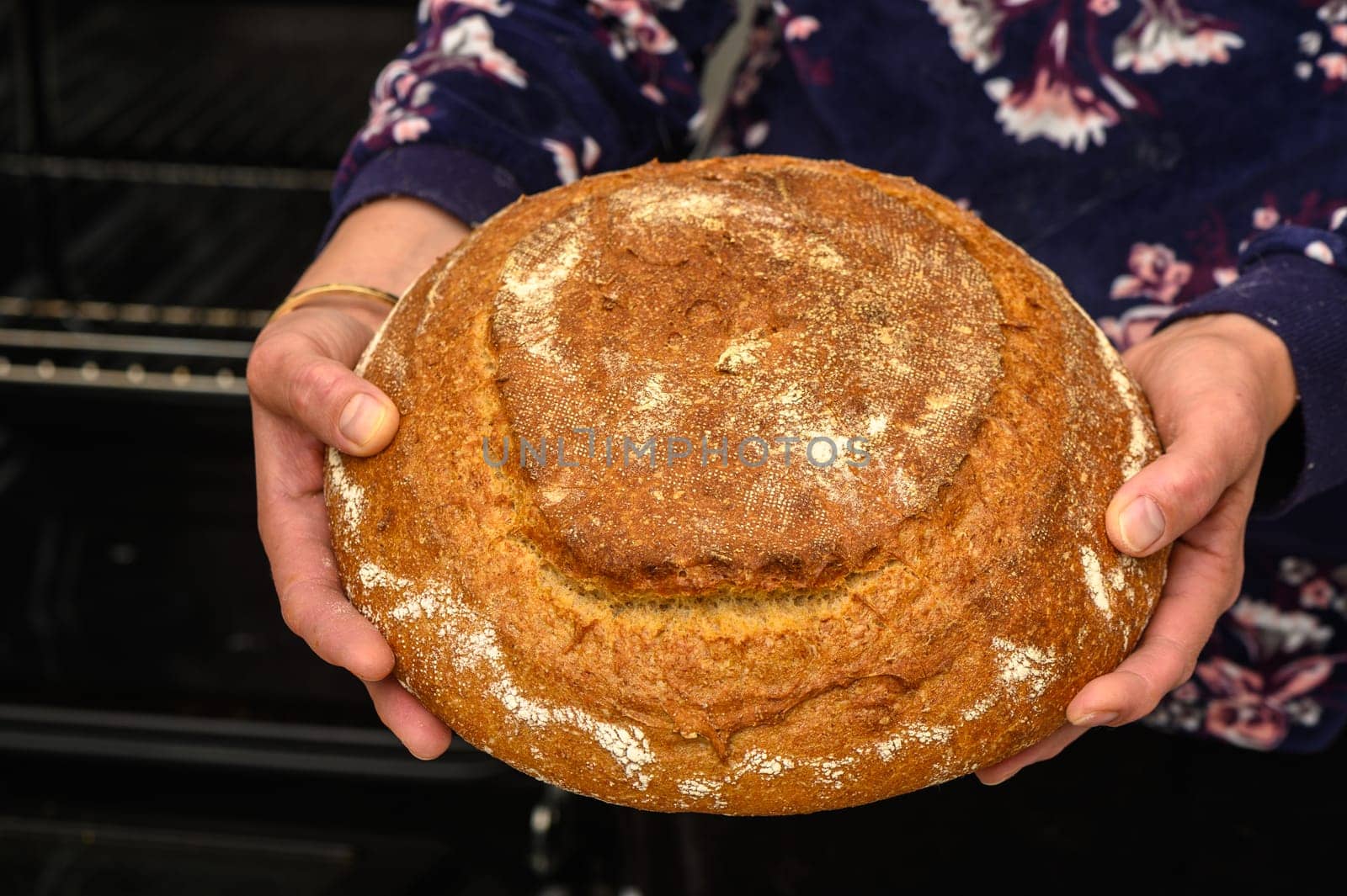 appetizing homemade whole grain bread in the hands of a woman 9