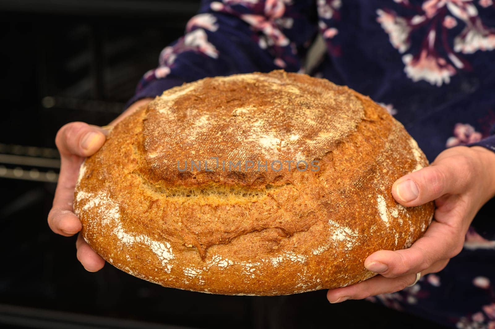 appetizing homemade whole grain bread in the hands of a woman 10