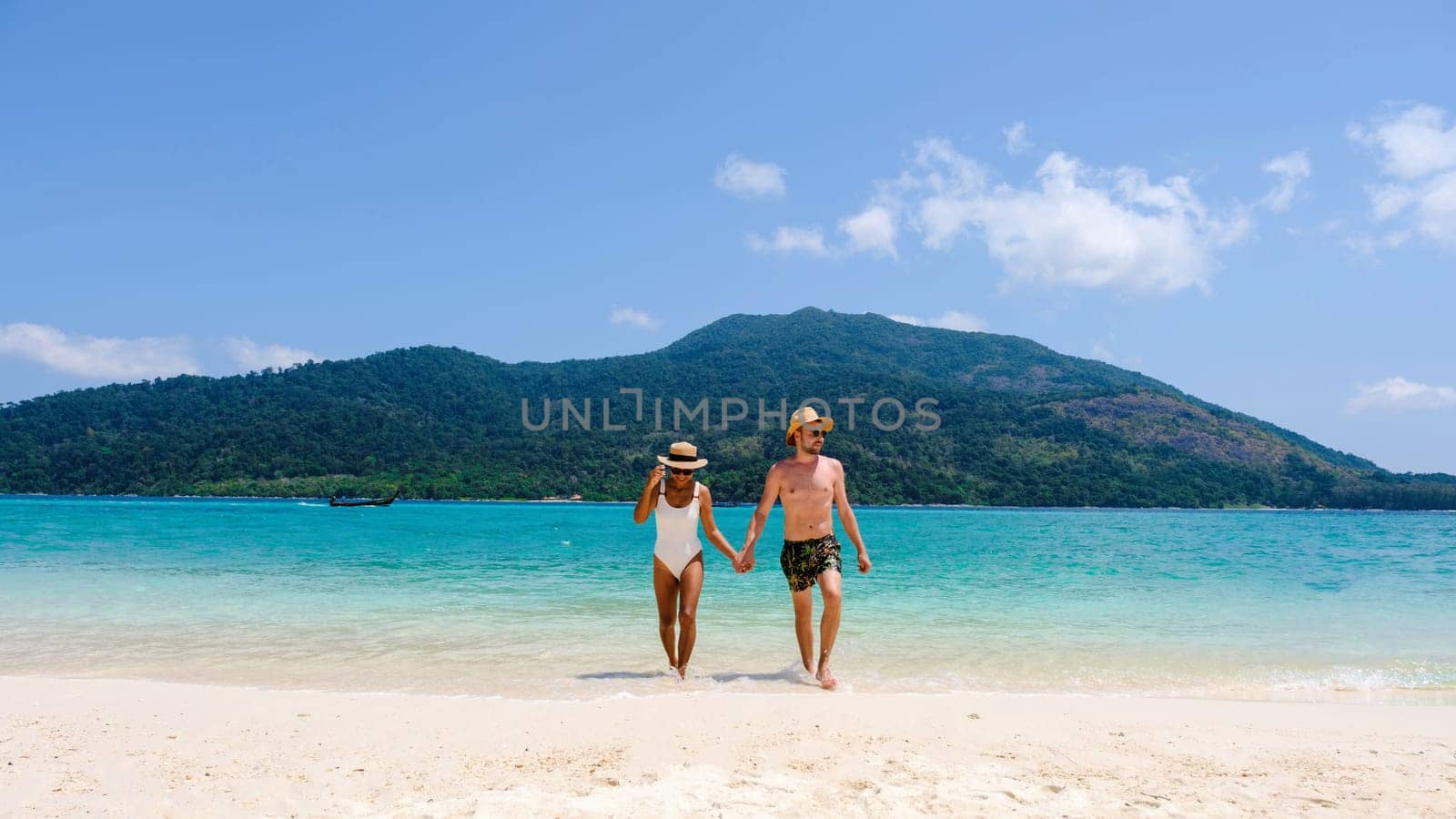 Couple on the beach of Koh Lipe Island Thailand, tropical Island with a blue ocean and white soft sand by fokkebok