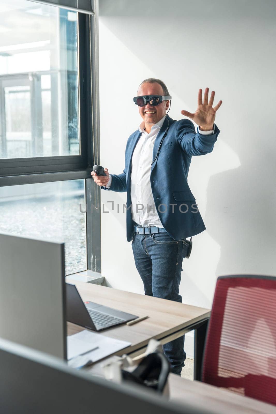 Businessman gesturing using new mixed reality goggles in the office by Huizi
