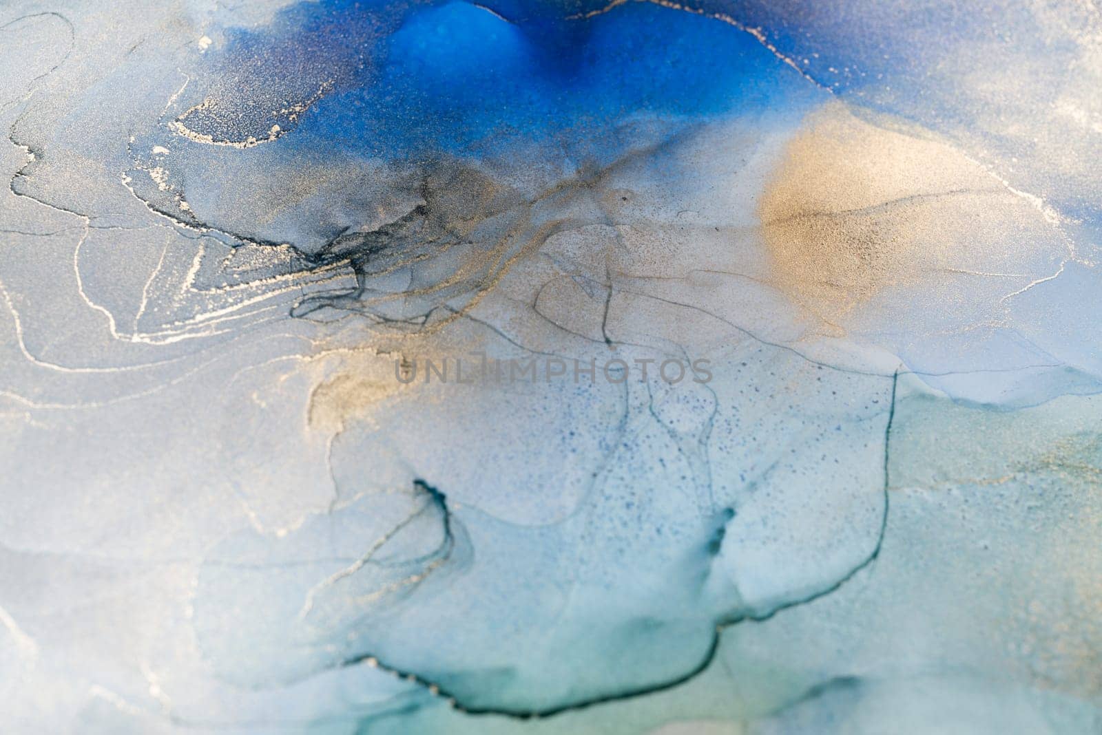 Abstract art with blue and gold background, beautiful smudges and stains made with alcohol ink. Abstract painting, background for wallpapers, posters, cards, invitations, websites.