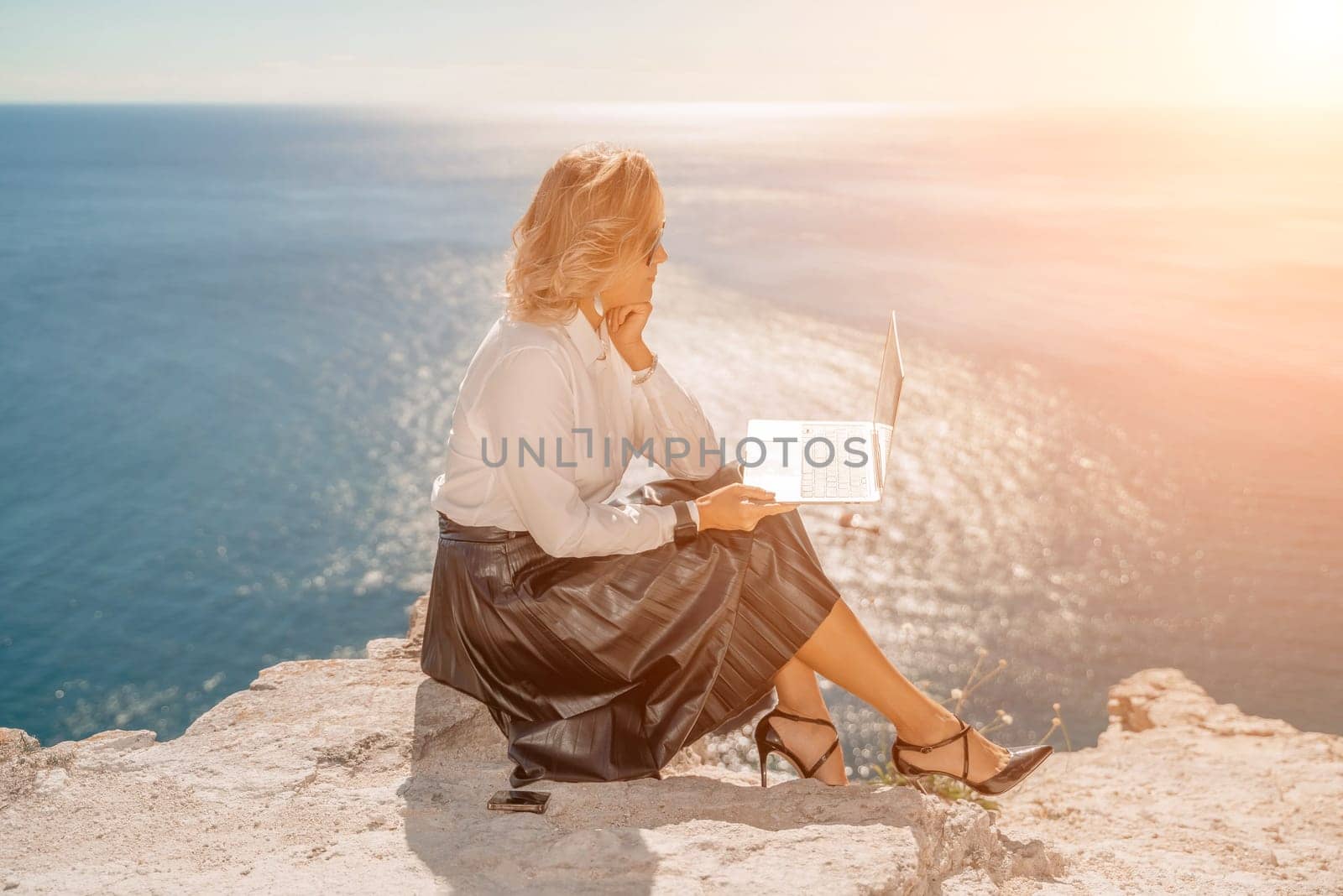 Business woman on nature in white shirt and black skirt. She wor by Matiunina