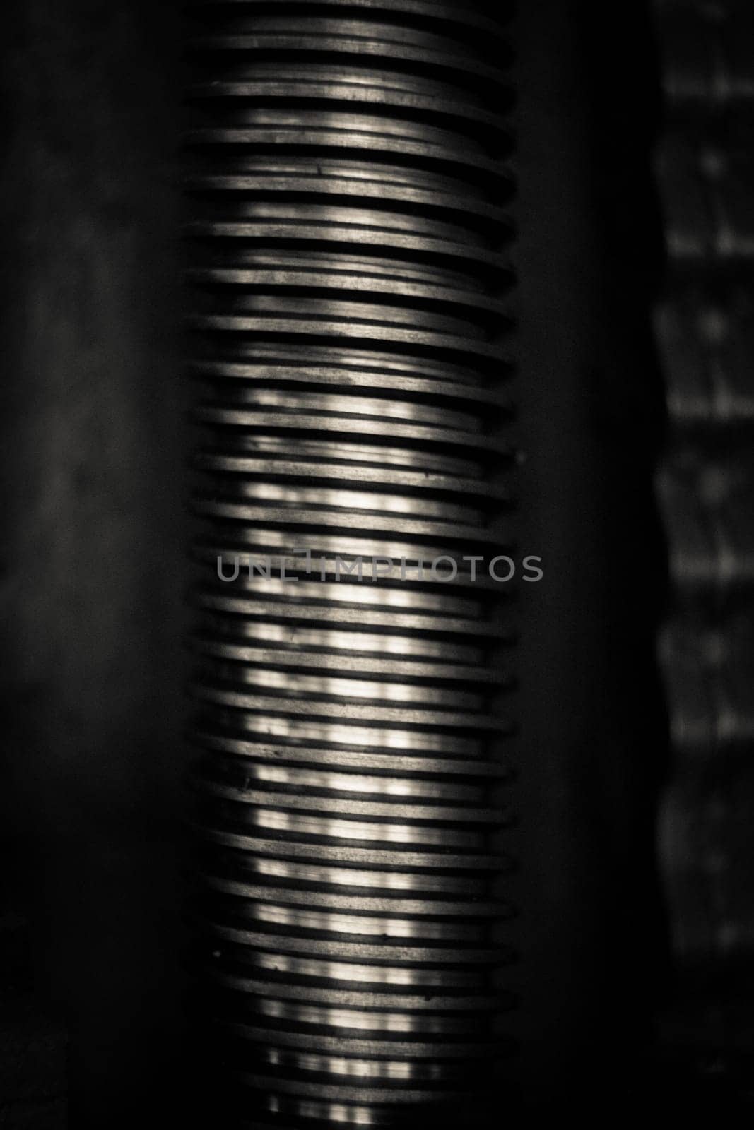 A close-up of metal rod with screw thread