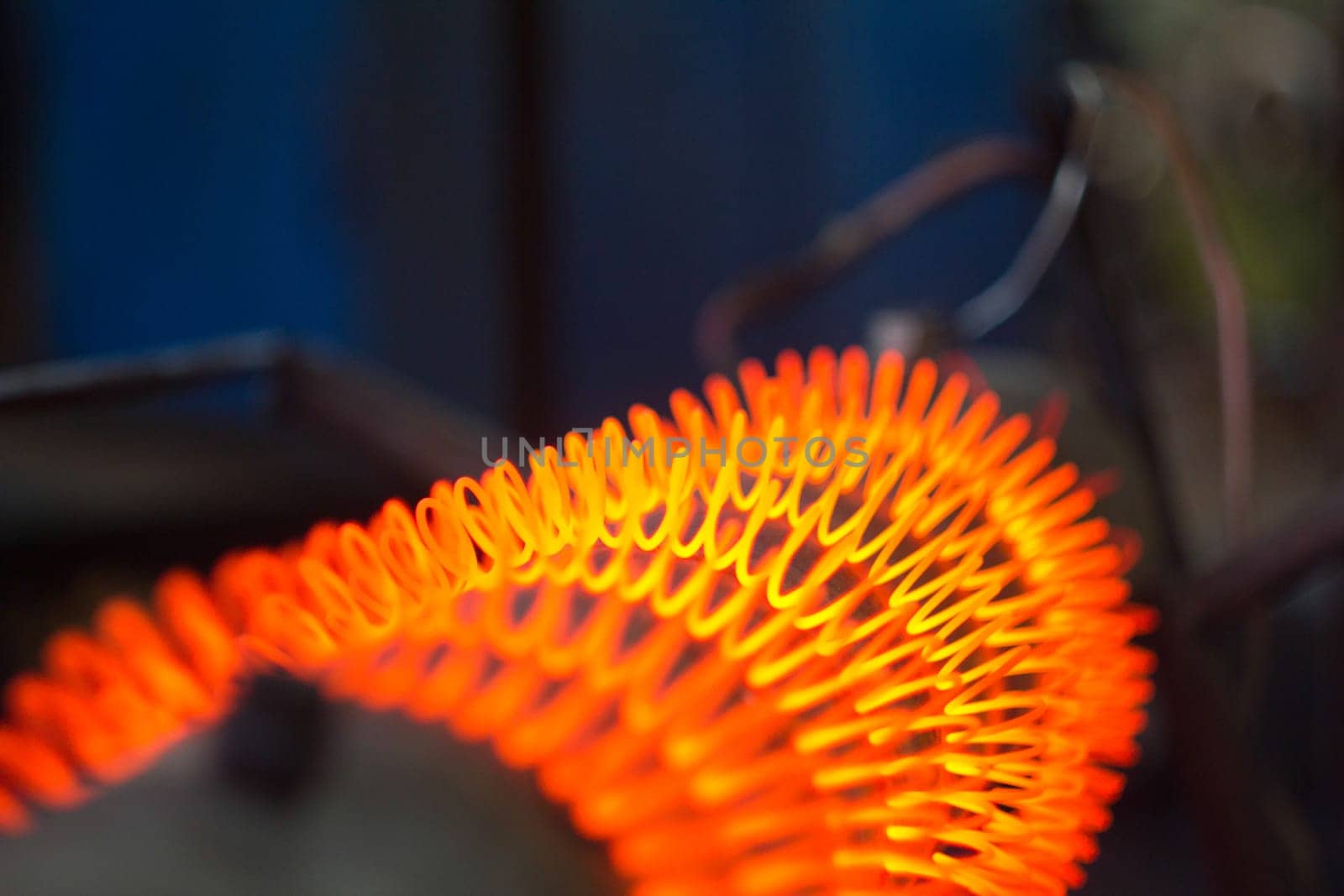 Red-hot spiral of nichrome thread on a metal pipe