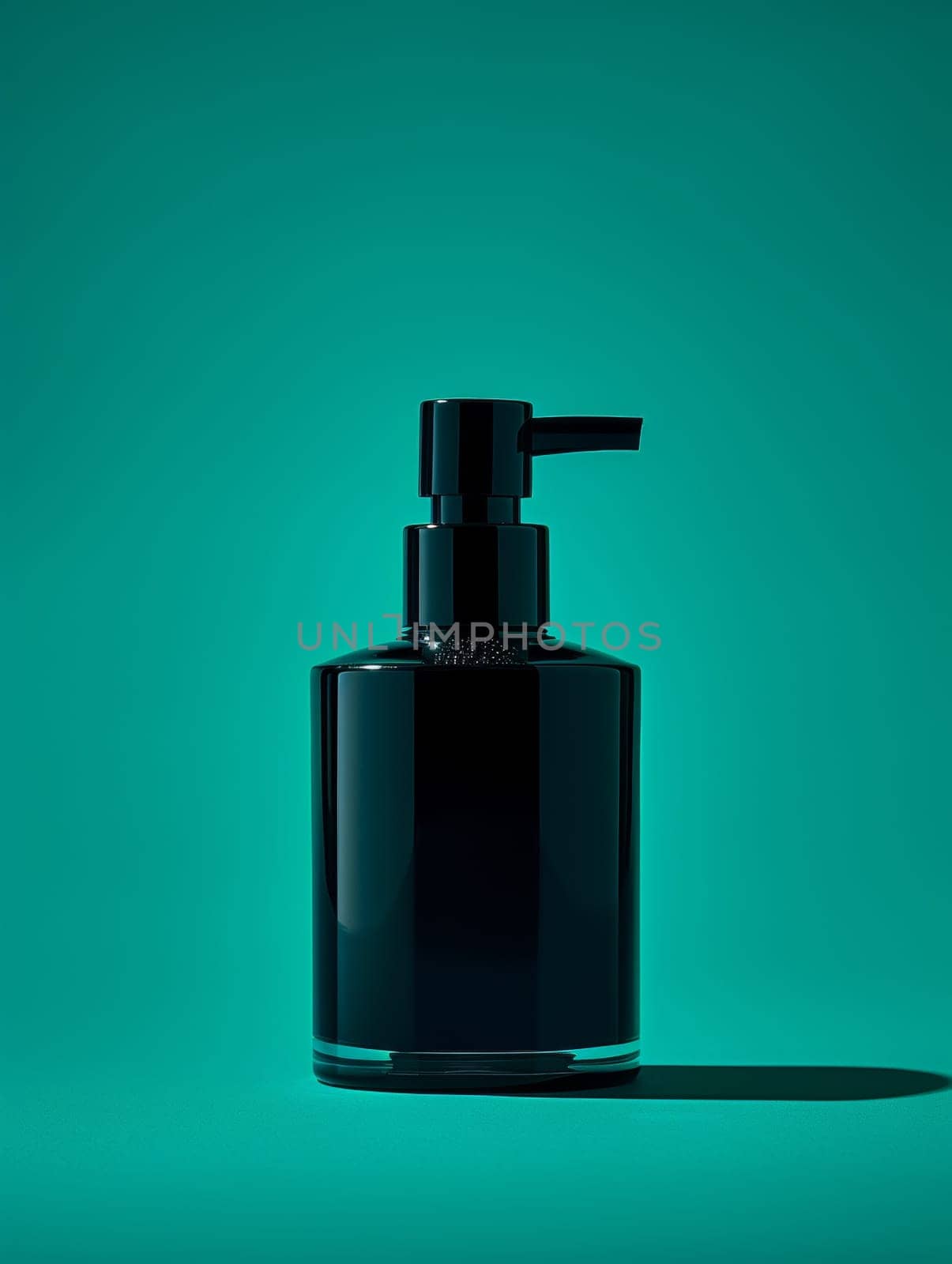 A black bottle of lotion on a green background