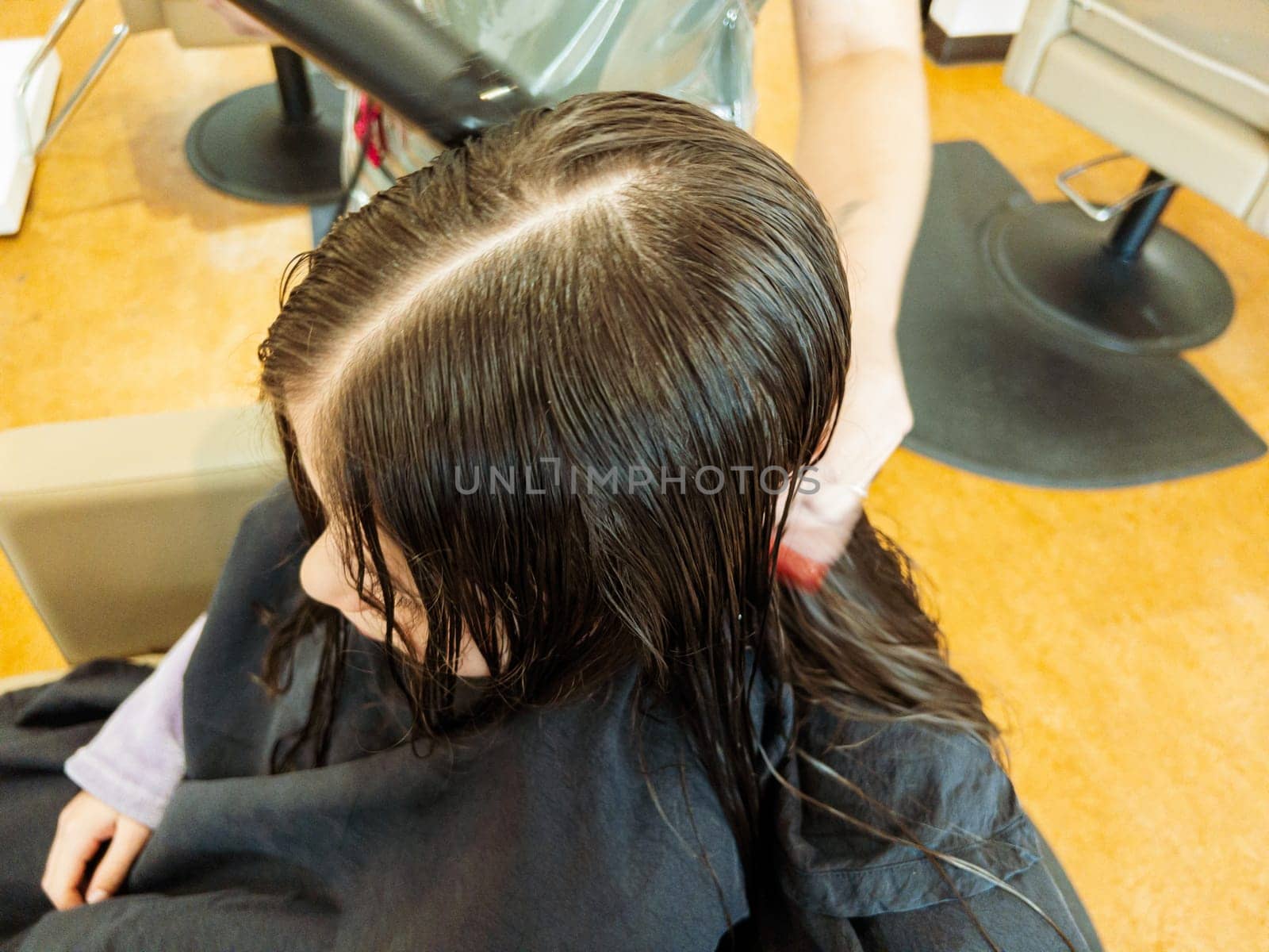 Final Touches with a Hair Dryer on a Little Girl's Fresh Cut by arinahabich