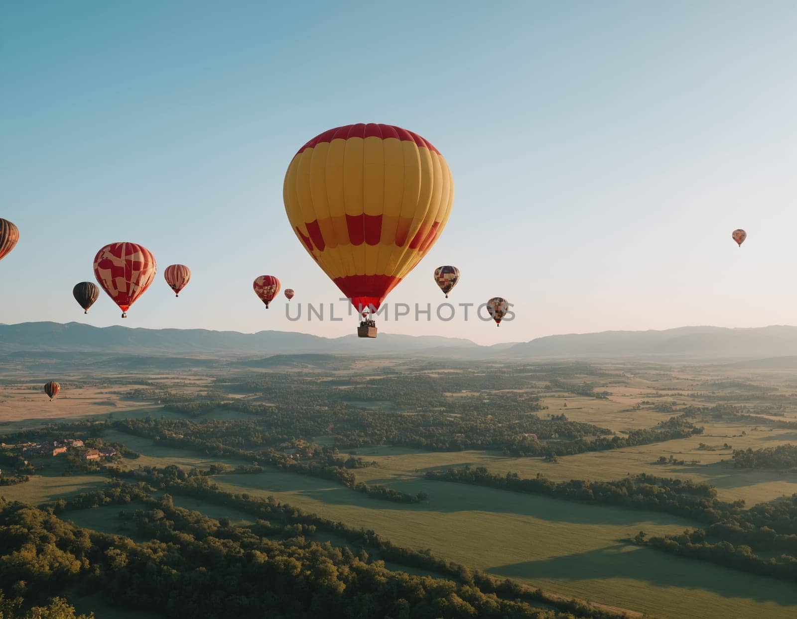 Spectacular views of colorful hot air balloons floating above the scenic landscape during golden hour. The image captures the essence of freedom and adventure.