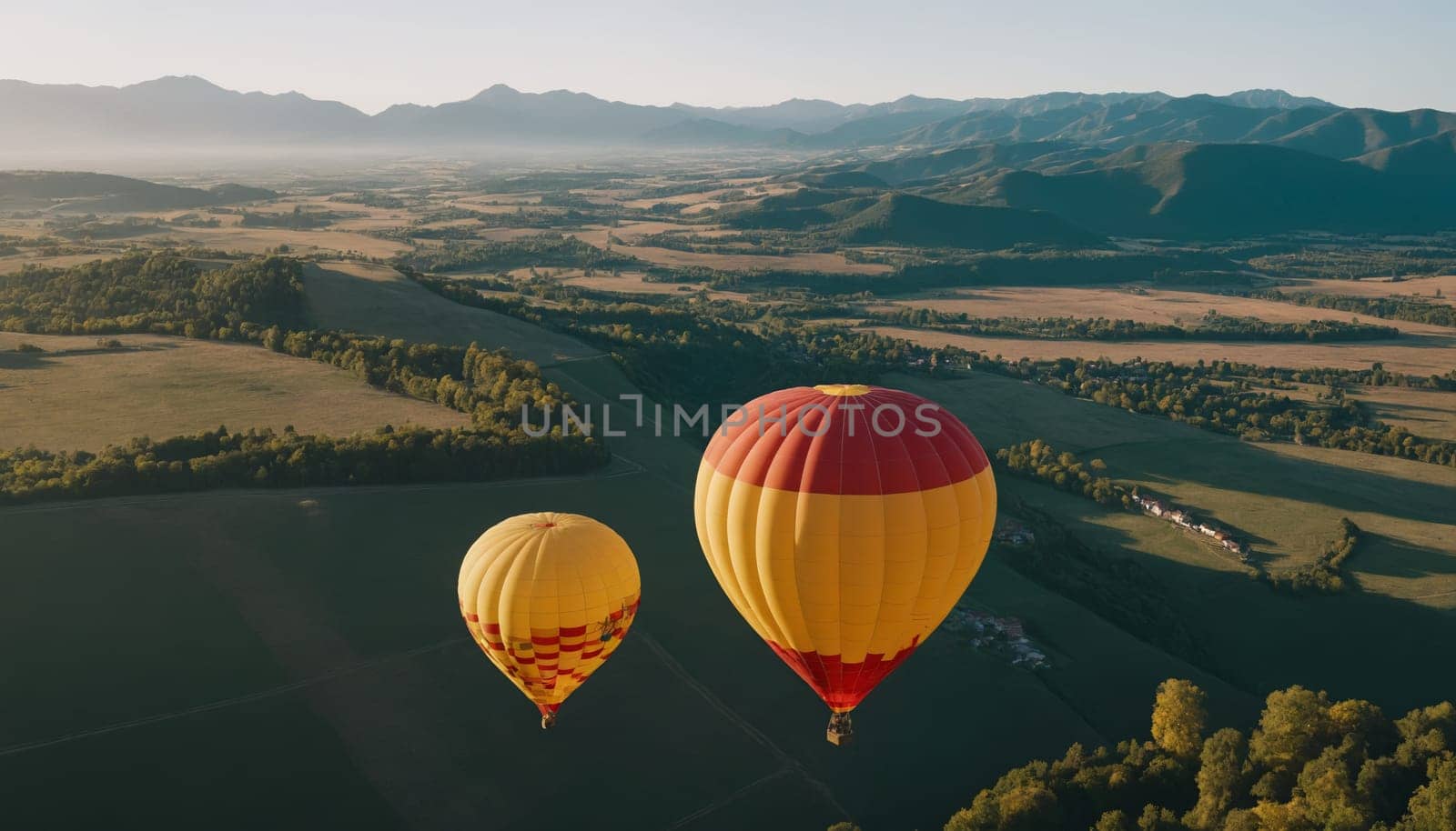Spectacular views of colorful hot air balloons floating above the scenic landscape during golden hour. The image captures the essence of freedom and adventure.