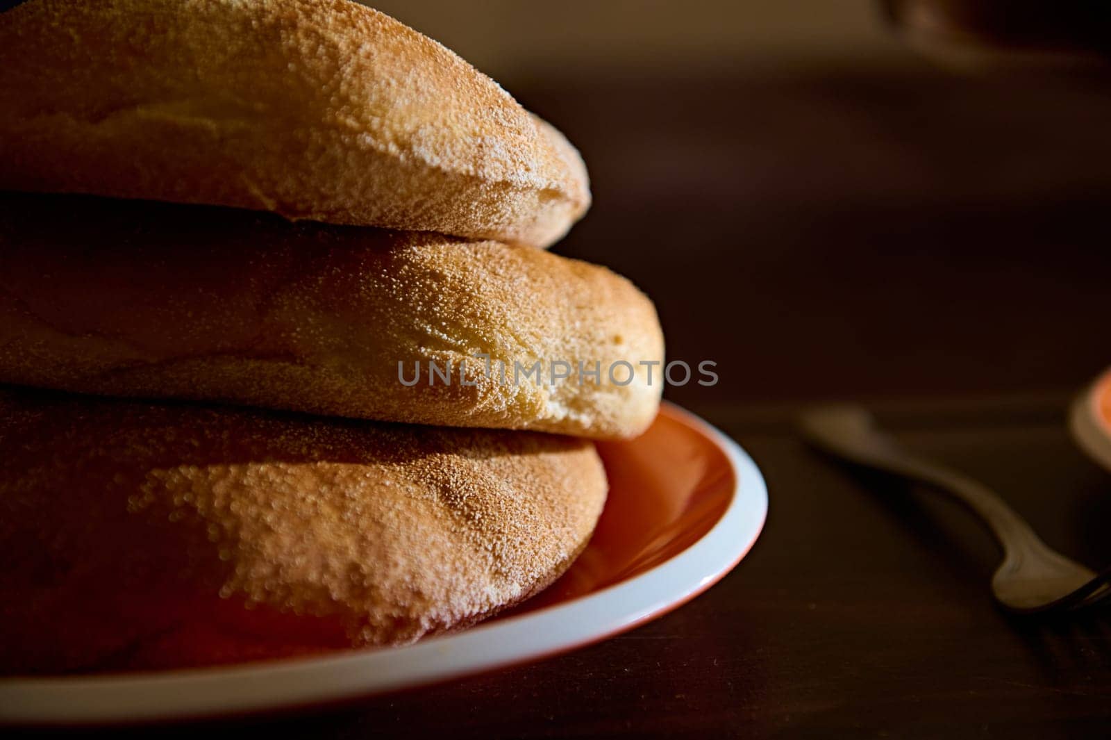 Partial view of fresh baked wholegrain bread on ceramic plate. Close-up food photography for advertising and food blogs by artgf