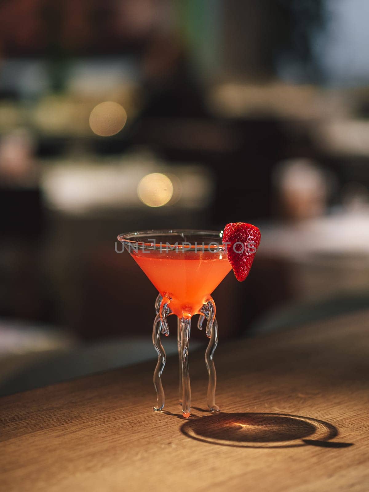 Strawberry margarita cocktail on bar counter by fascinadora