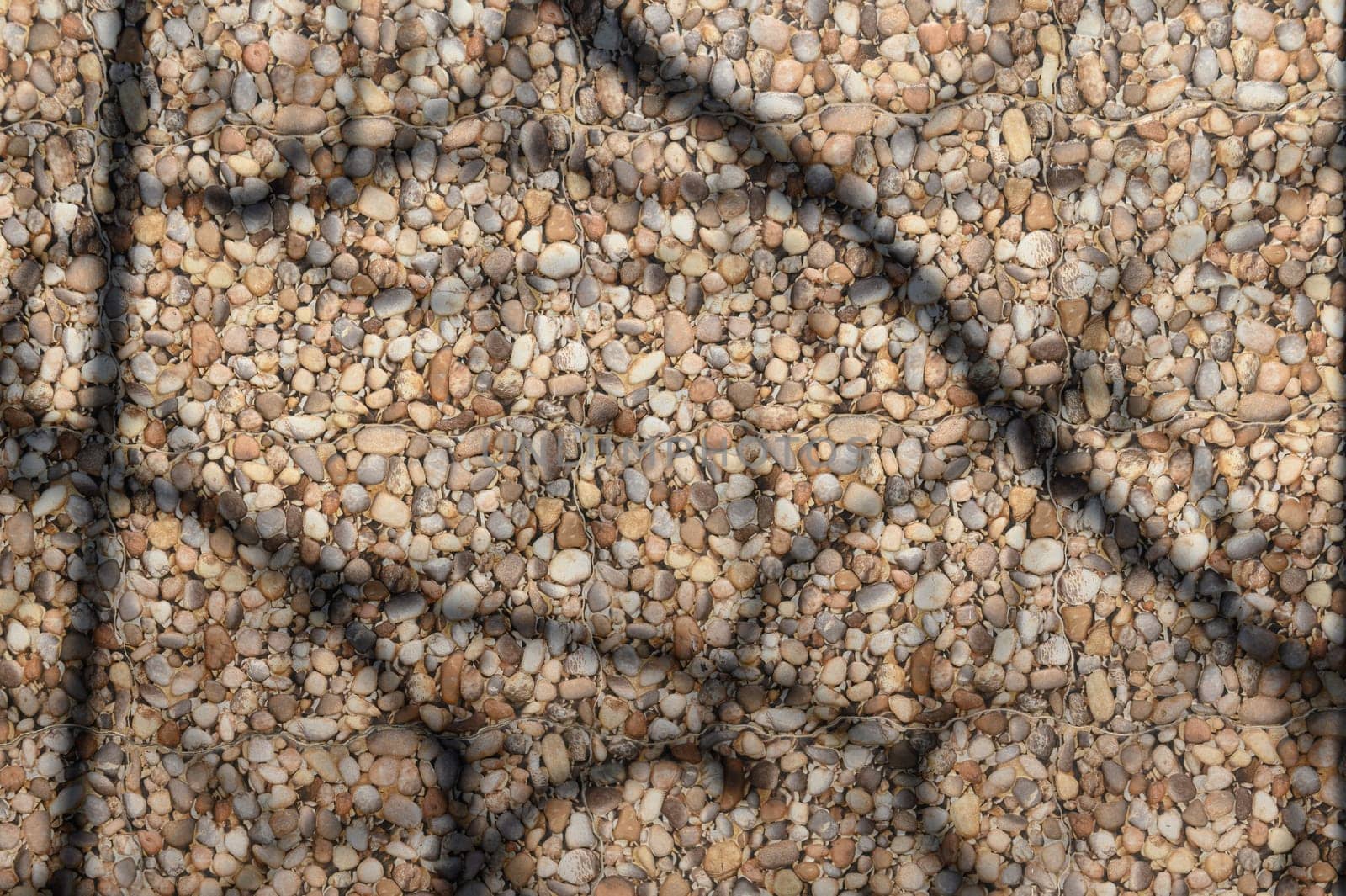 sea ​​stones and shadows from branches on the wall as a background