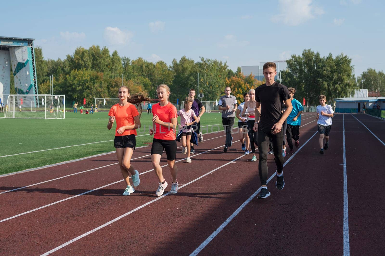 Group of young athlete runnner are training at the stadium outdoors