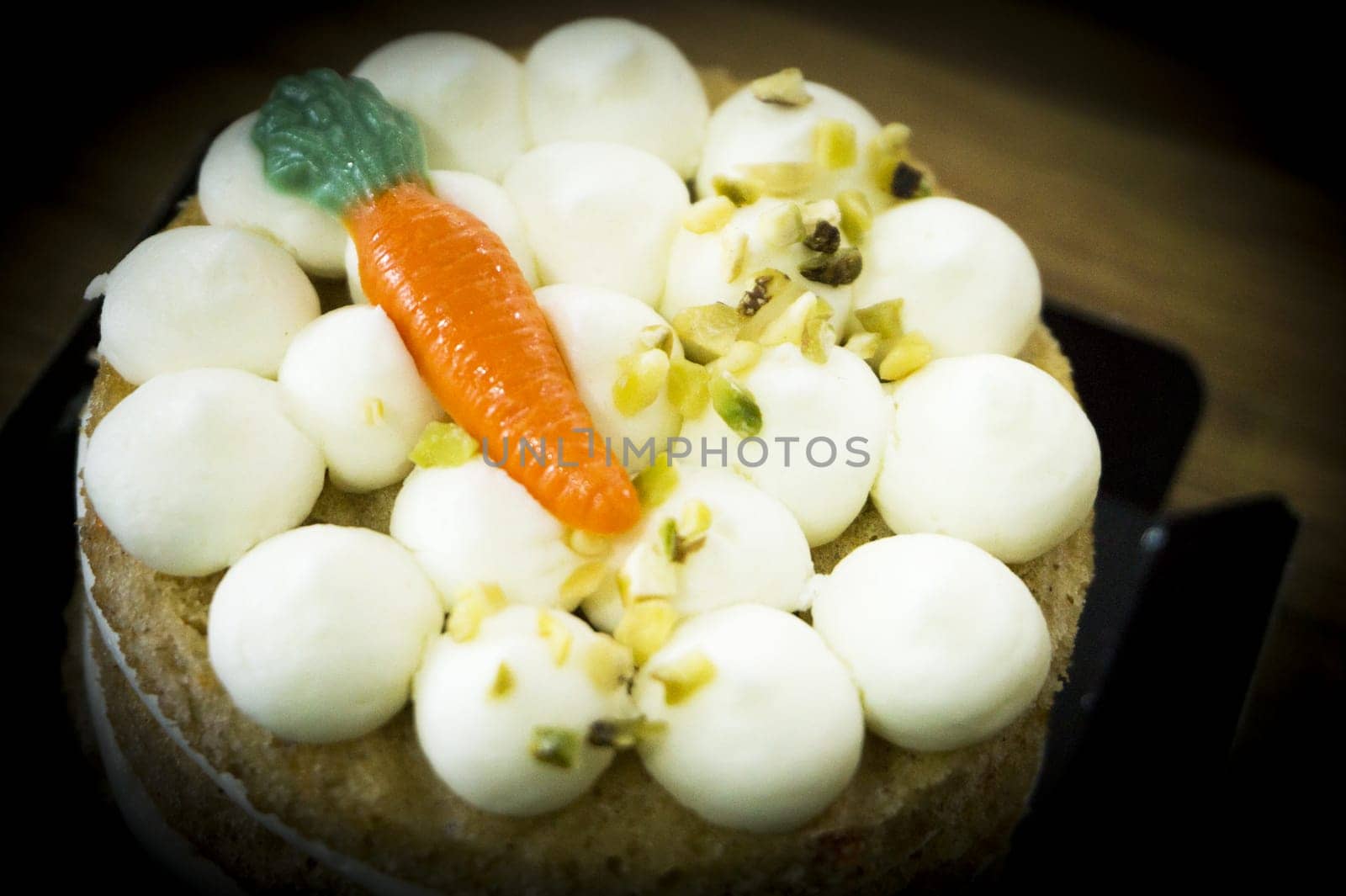 Carrot cake on wooden table. No people