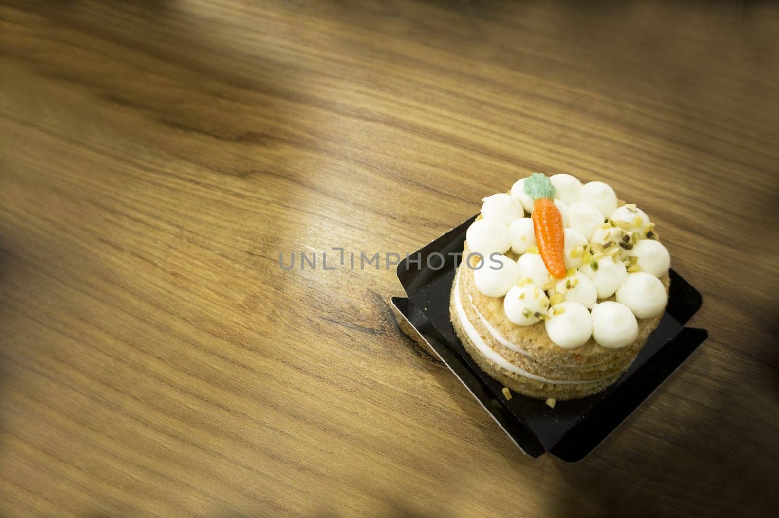 Carrot cake on wooden table. No people