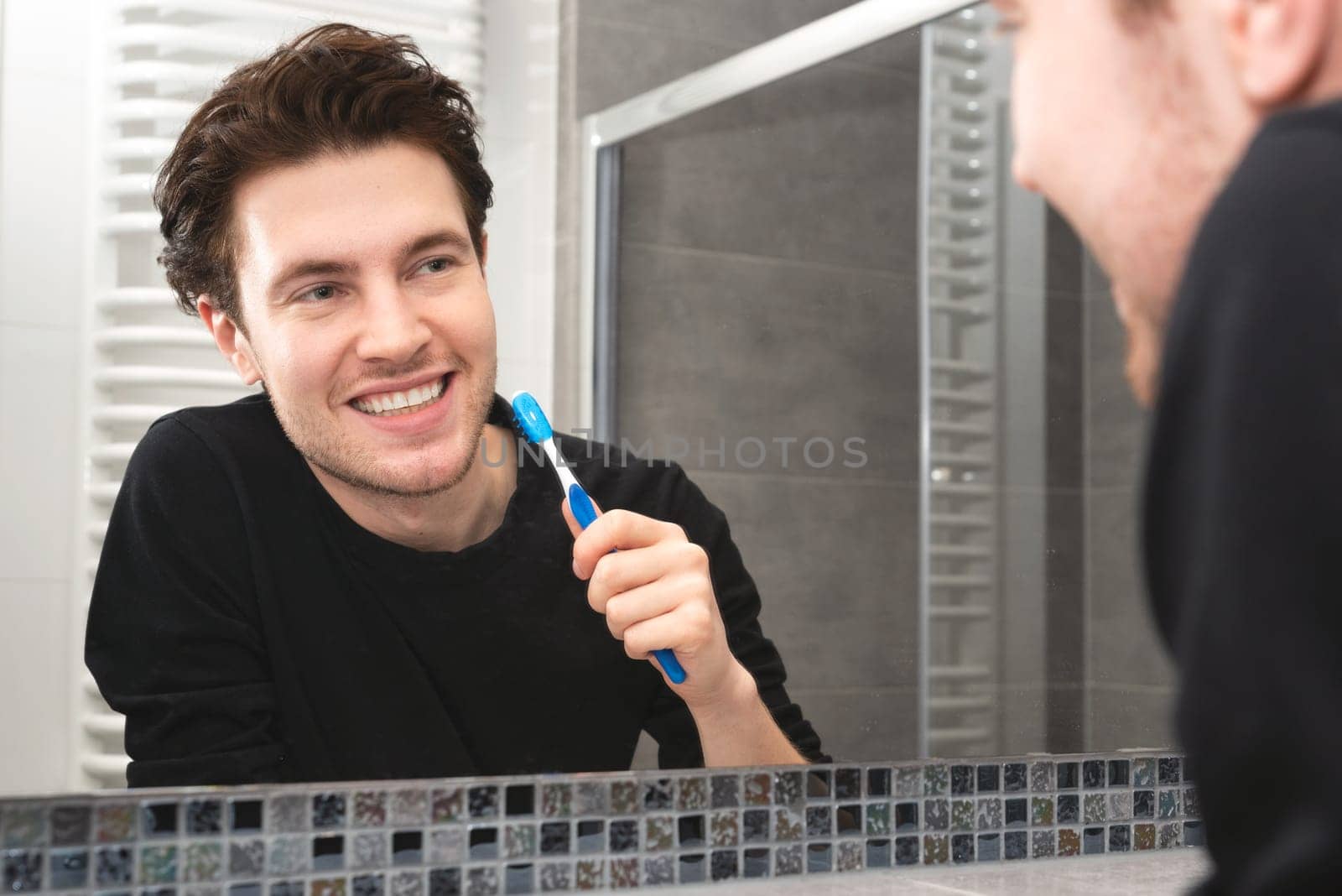 Man brushing teeth in bathroom by simpson33