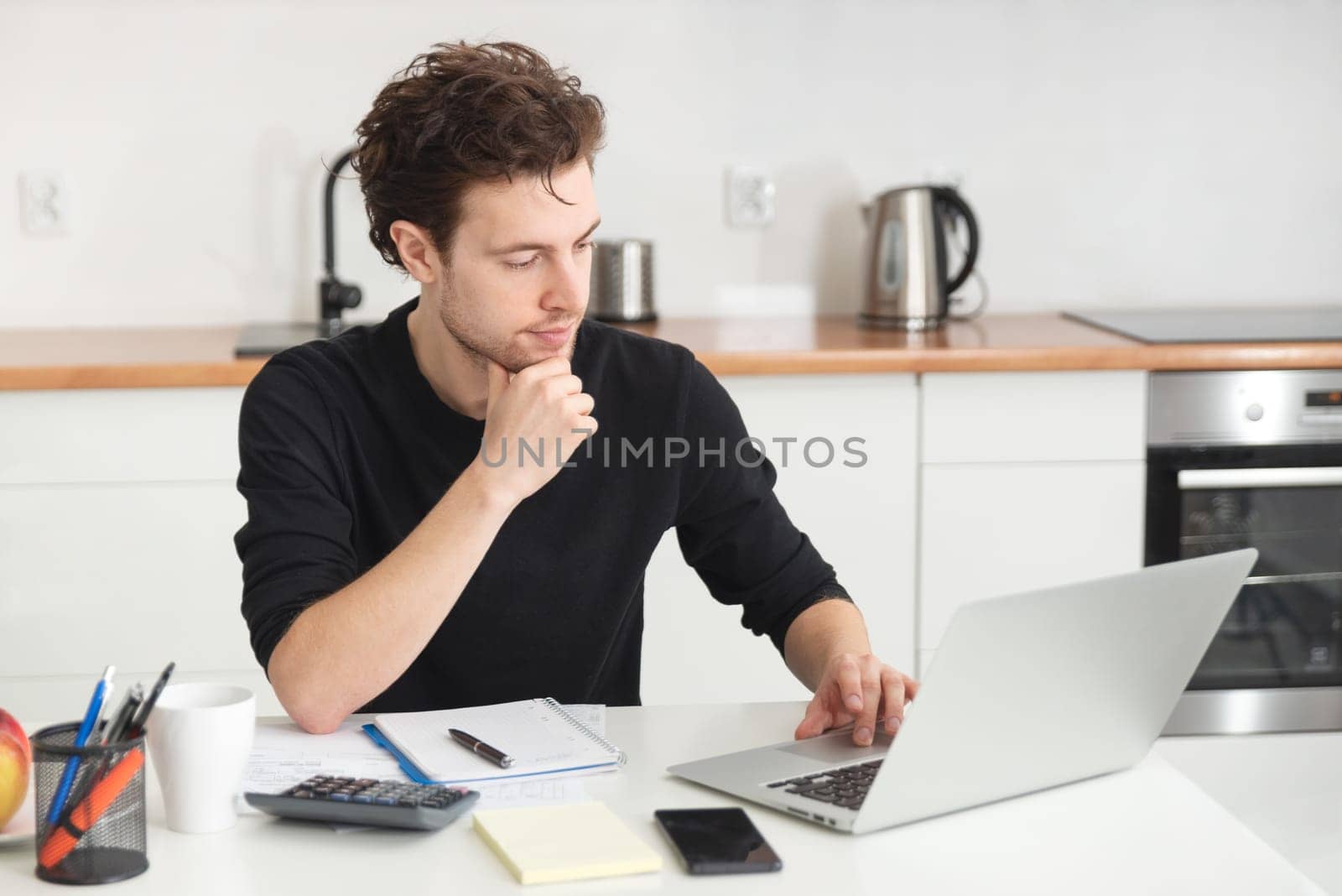 Man using laptop at home. Job search or remote work concept