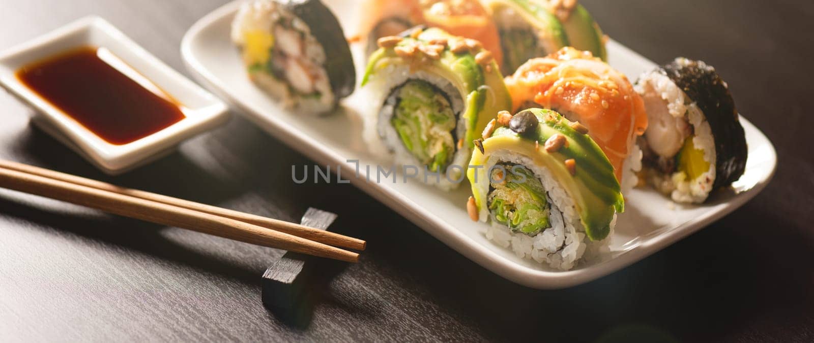 Sushi roll set on plate. Japanese Asian traditional food front view