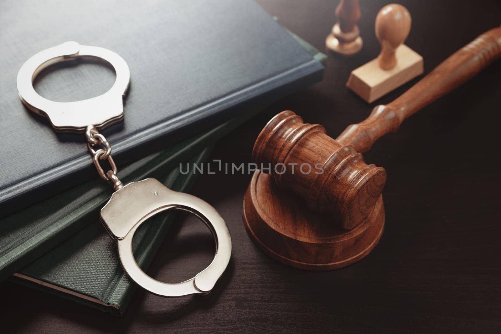 Arrest concept. Metal handcuffs near judge gavel by simpson33