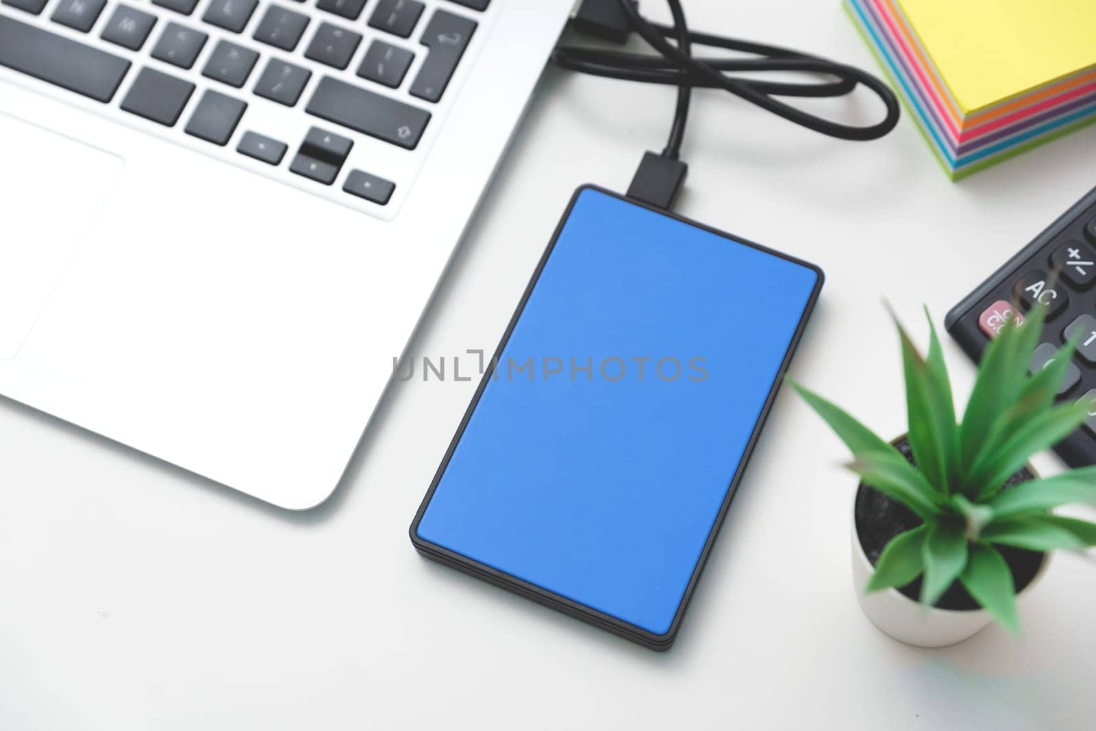 External backup disk, USB hard drive connected to laptop.