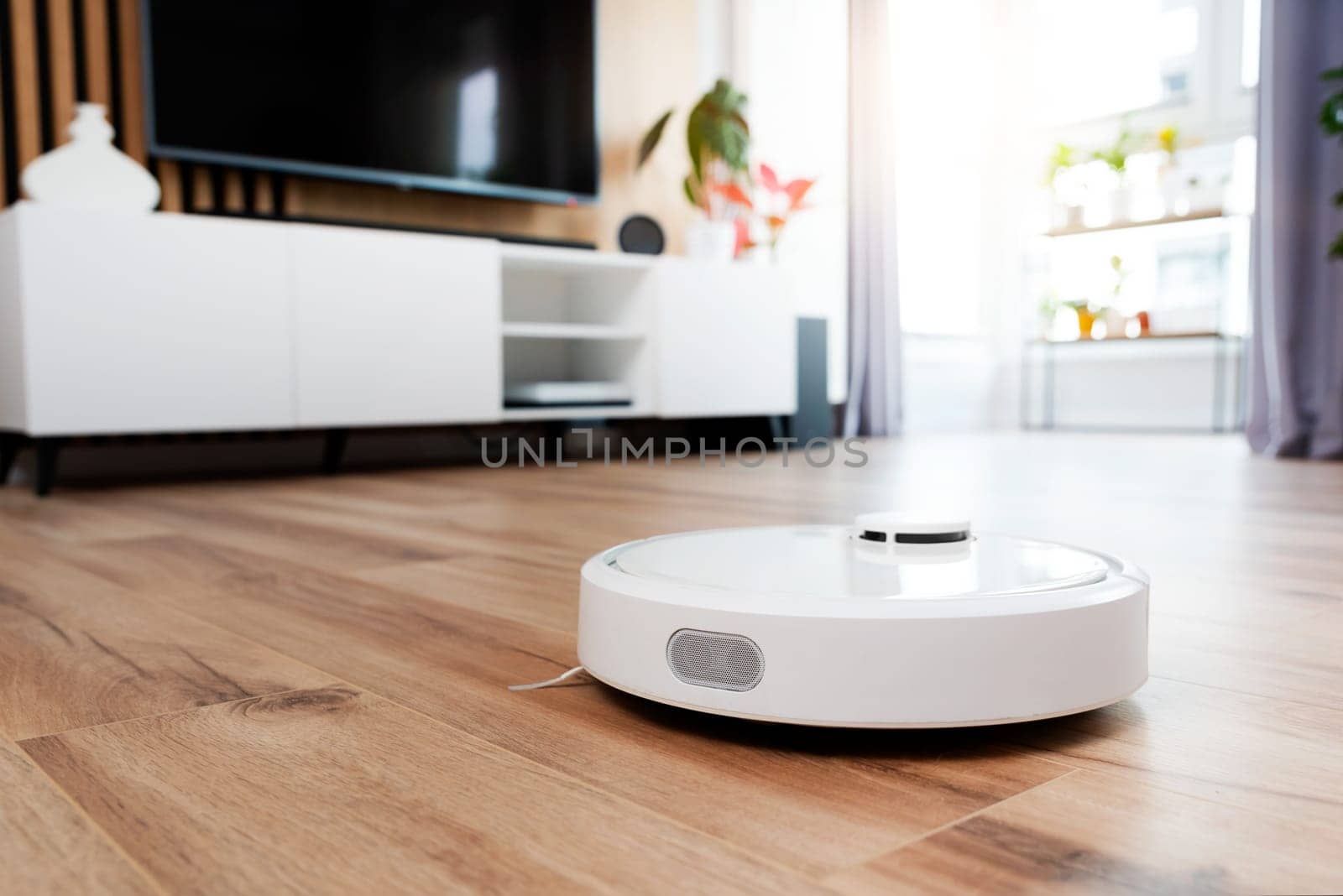 White robot vaccum cleaner in the living room by simpson33