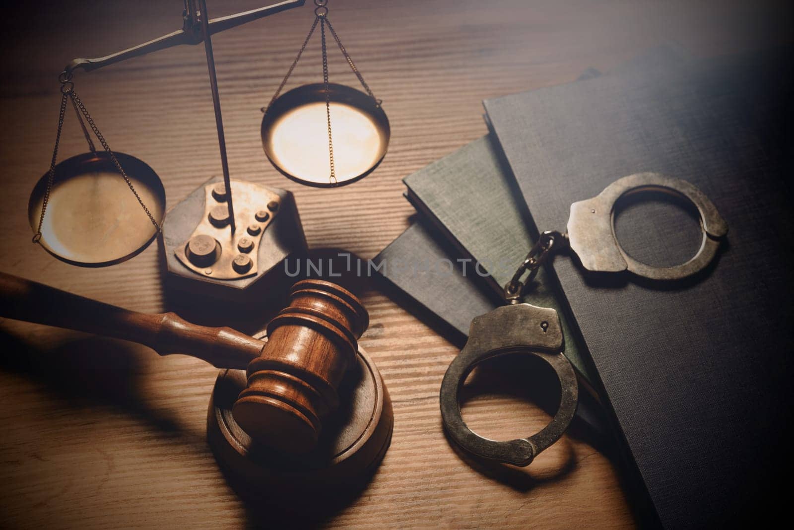 Gavel, weight scale, handcuffs on desk. Law and crime concept