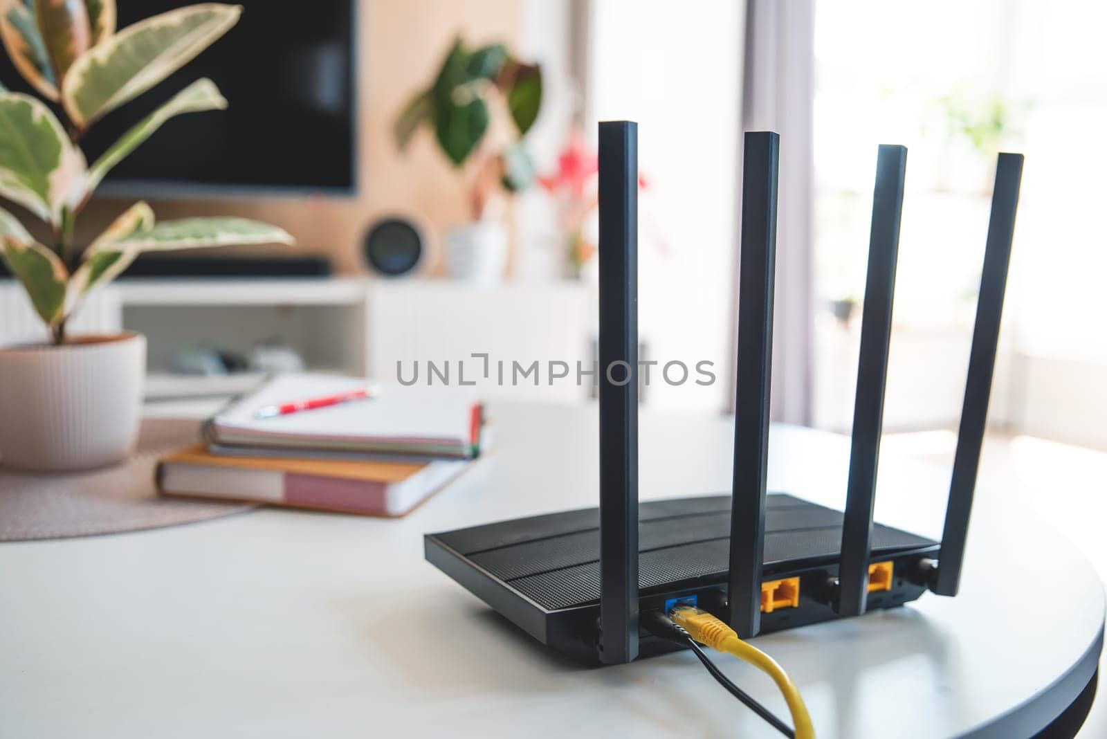 Router with 4 antennas in living room. High speed internet concept