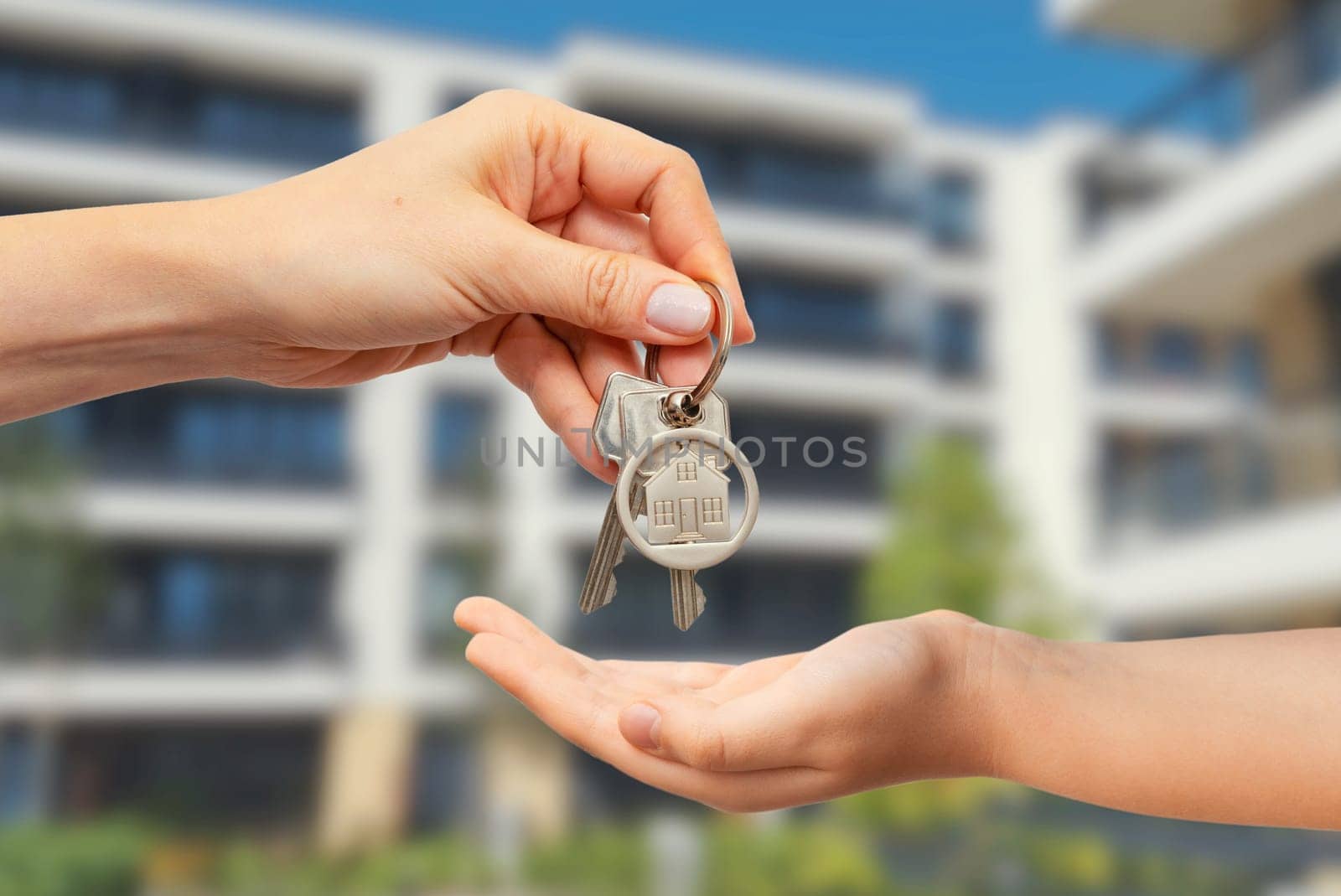 Real estate concept with home keys in hand by simpson33