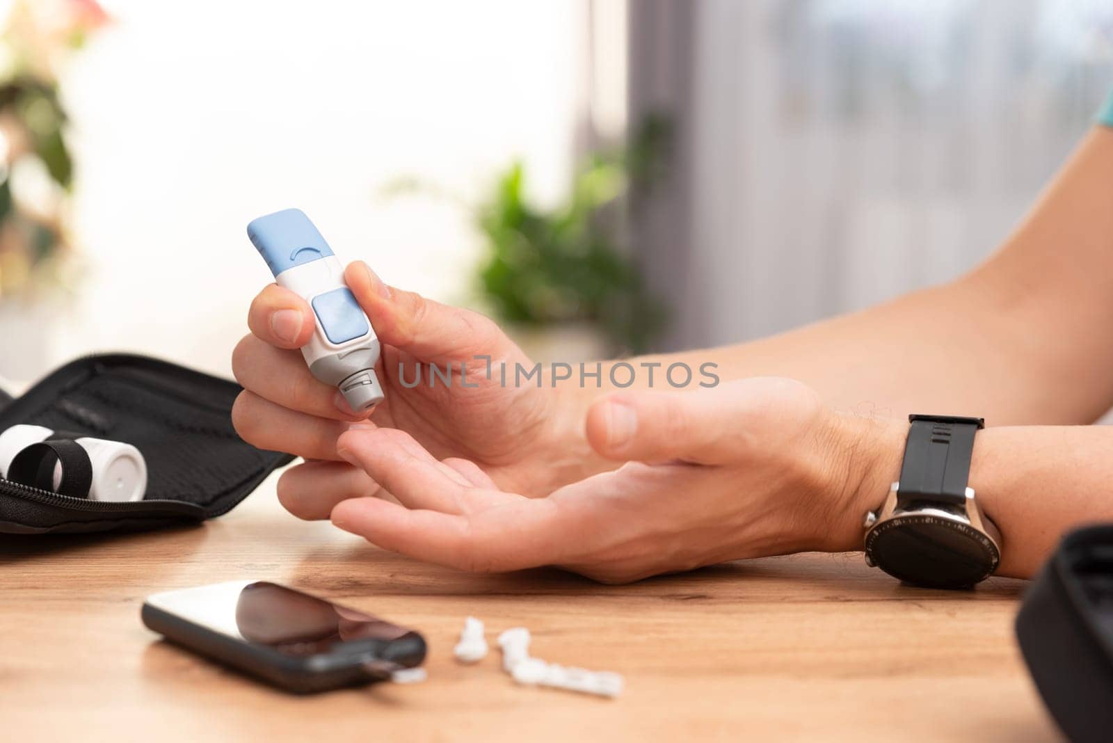 Diabetes doing sugar blood test, using glucometer and lancet