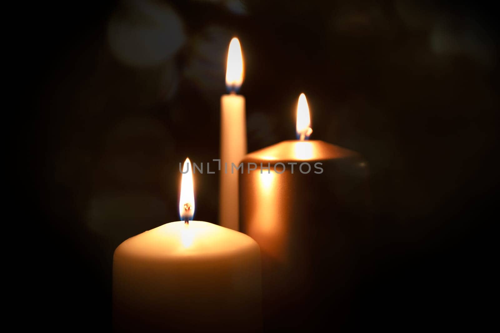 Funeral symbol with burning candle in darkness by simpson33