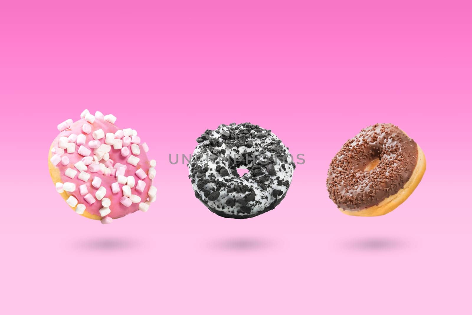 Delicious donut on color background. Mix of flying multicolored doughnuts