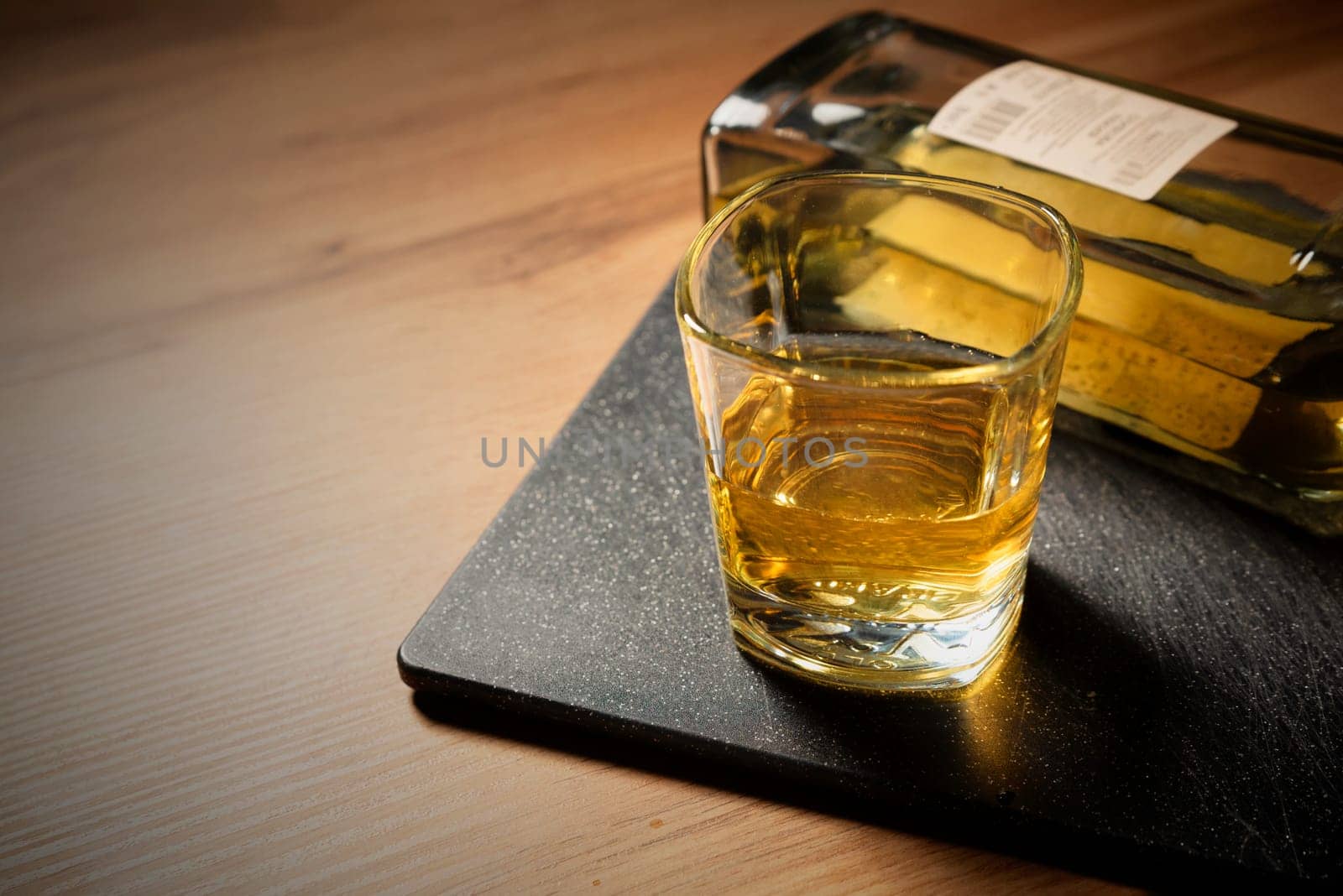 Glass of whiskey on the table, alcohol problem