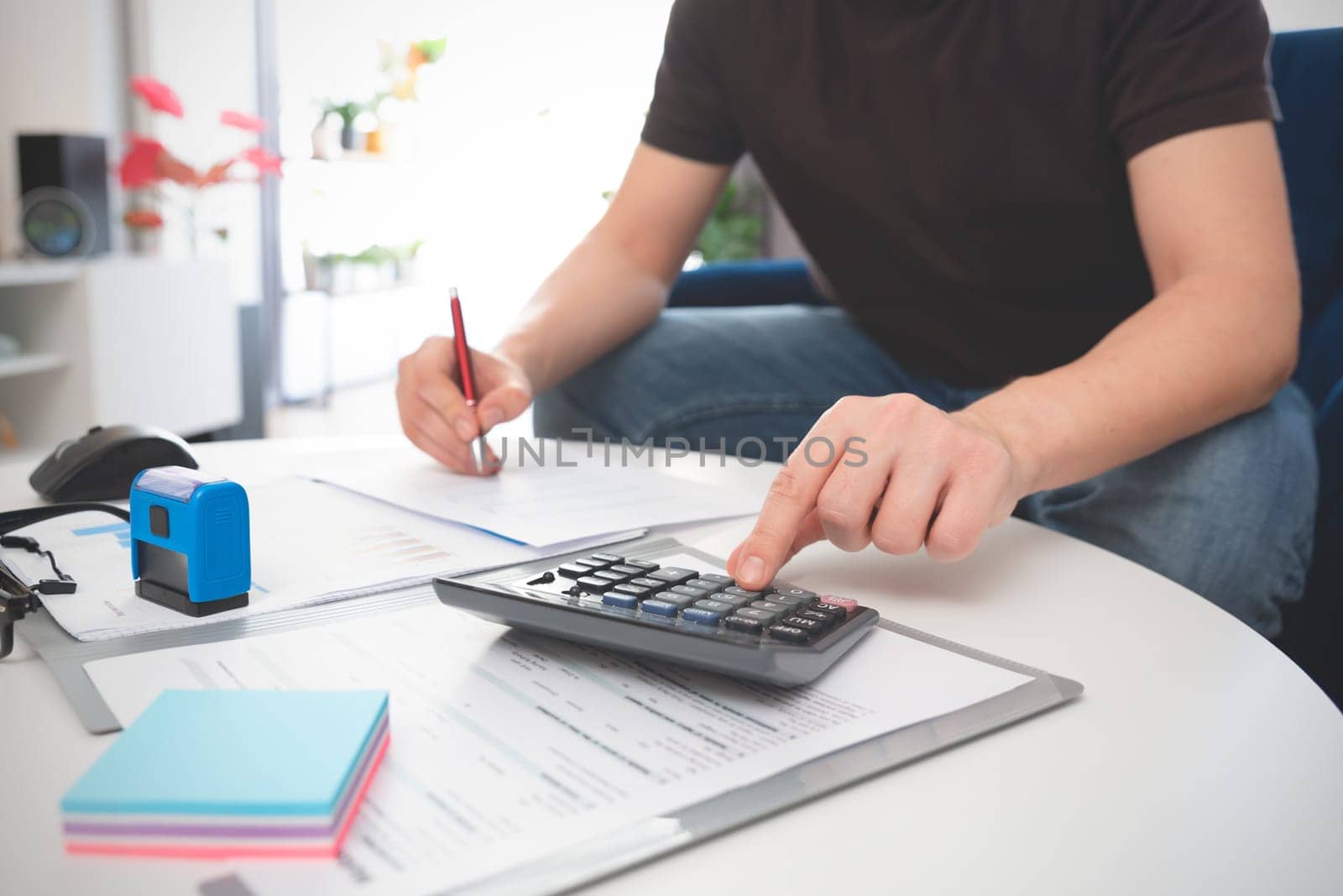 Budget and loan paper in office. Business accounting concept with businessman using calculator.