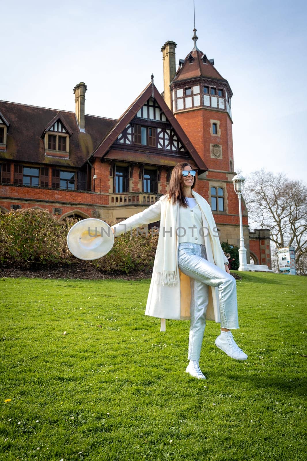 Stylish woman with white coat and hat at the Miramar Palace, San Sebastian