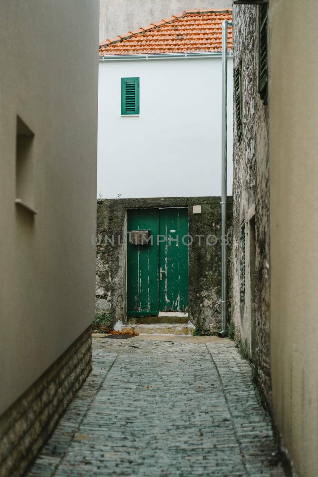 Old narrow street with house facades of Old Town, Biograd na Moru in Croatia by Popov