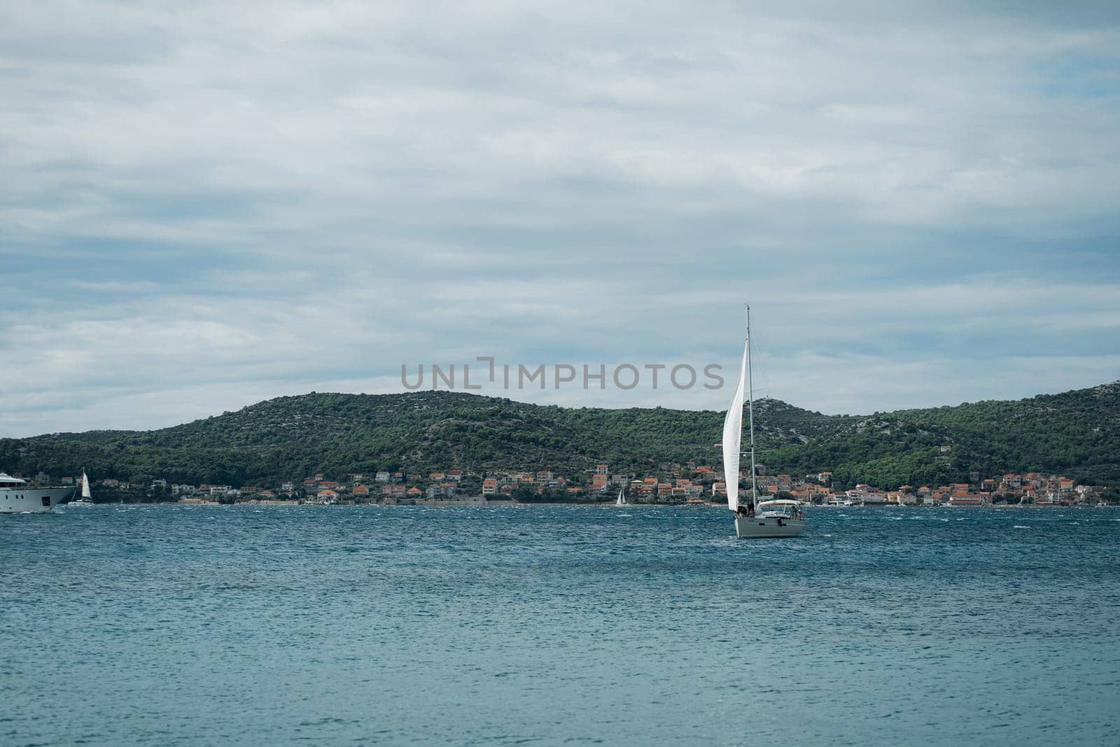Modern boat sailing near shore of Biograd na Moru of Croatia by Popov