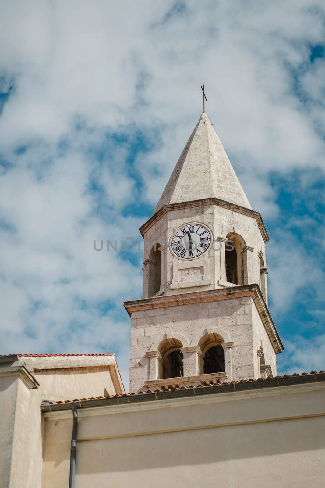 Ancient tower with vintage clock dial in Biograd na Moru of Croatia by Popov