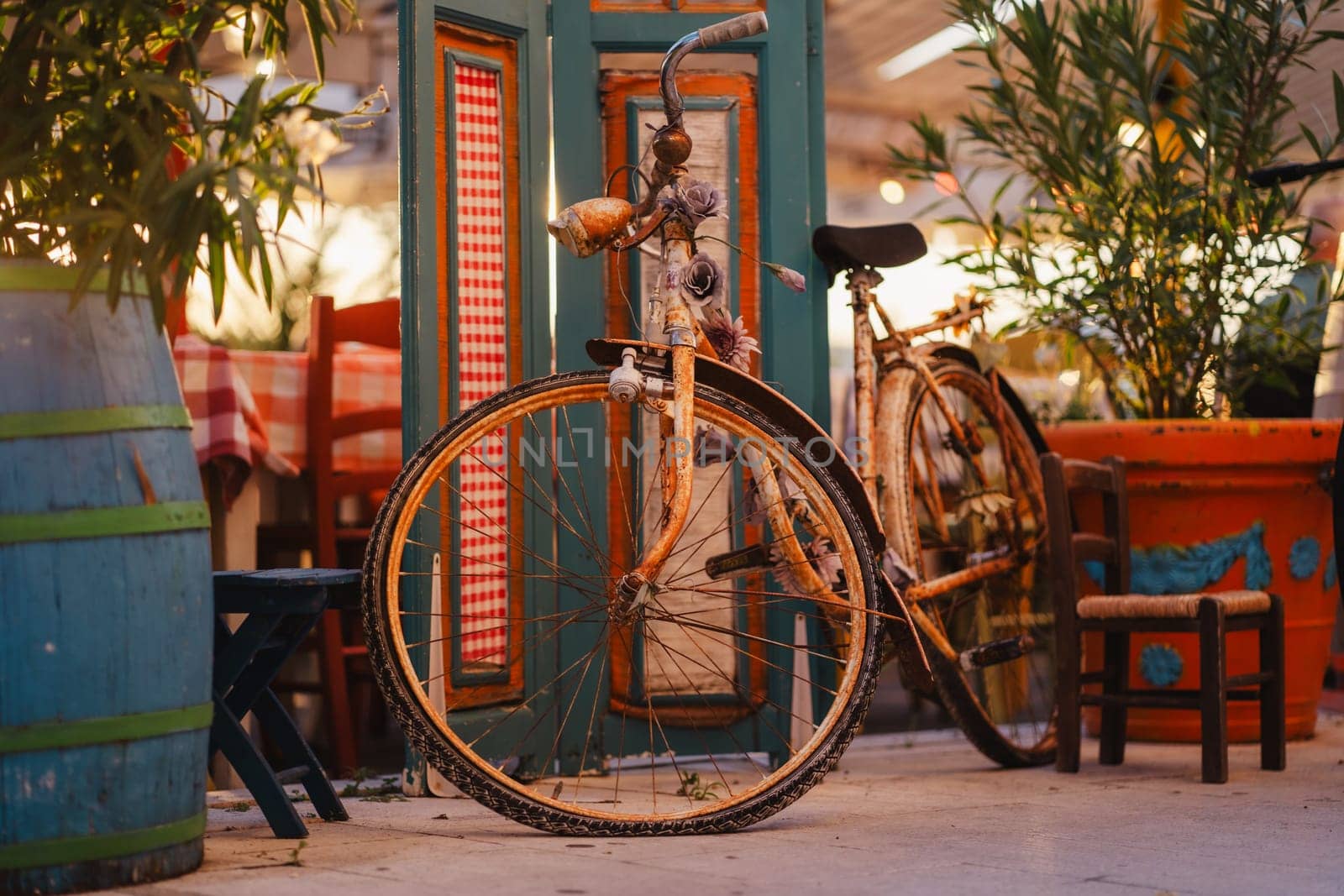 Old bicycle parking in outdoor cozy cafe in Biograd na Moru port of Croatia