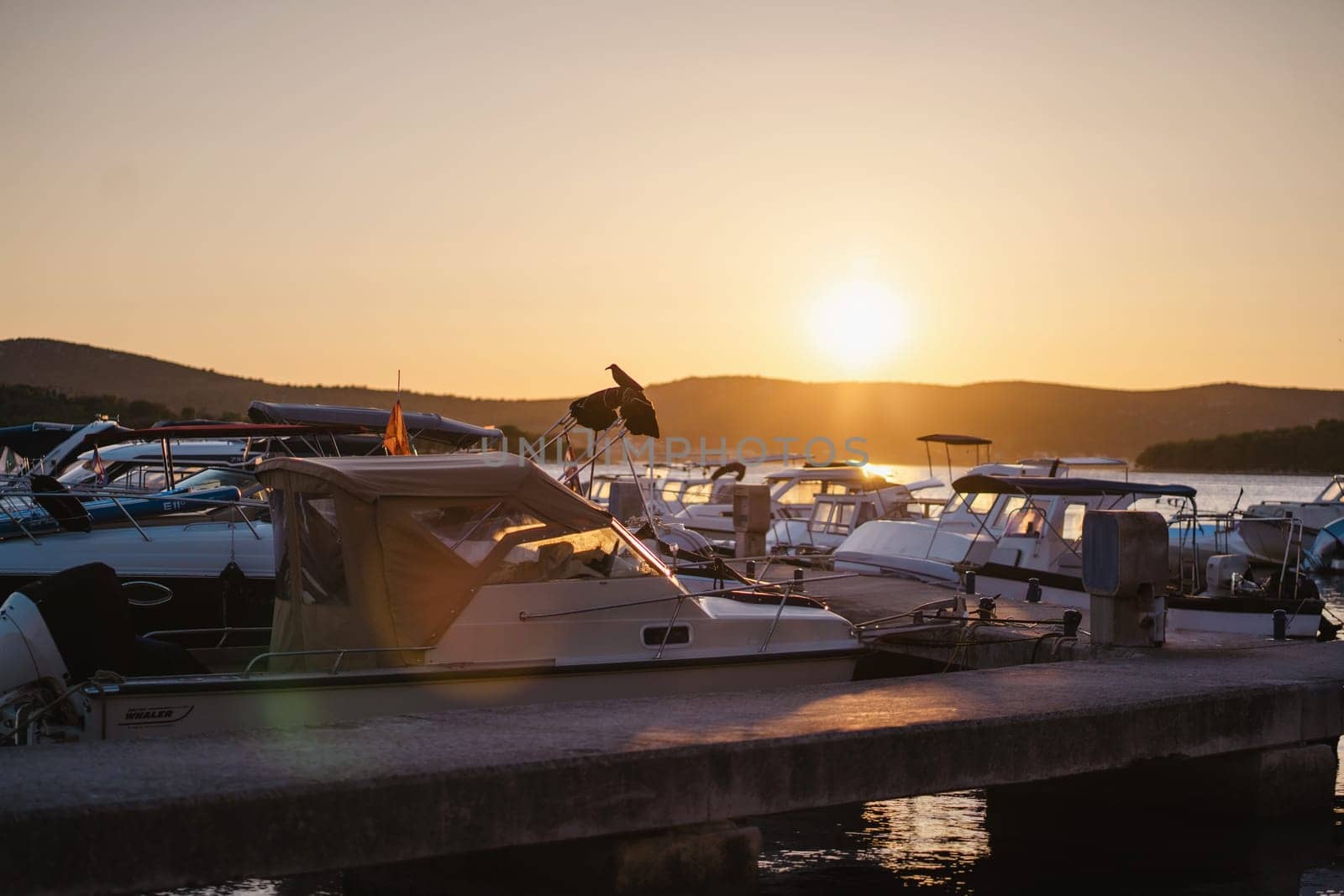Sunset in Biograd na Moru port of Croatia, yachts and motor boats at pier by Popov