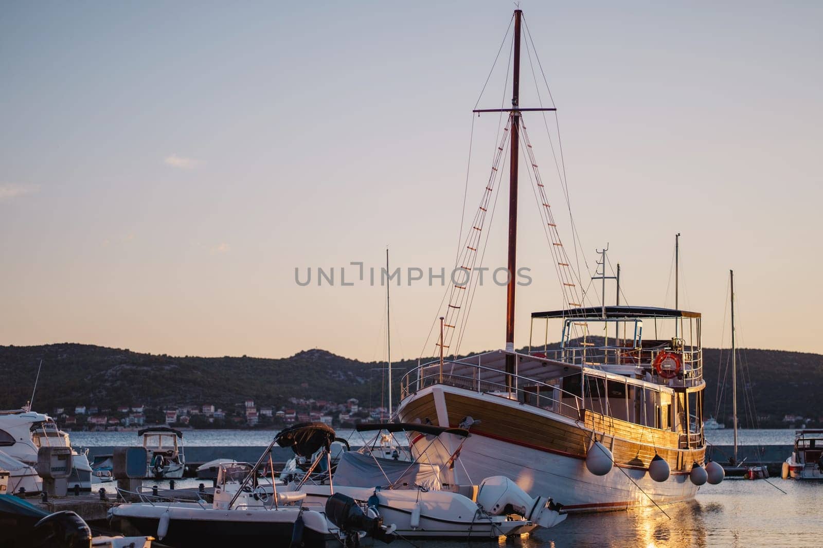 Sailboat moored at pier of Biograd na Moru, Croatia at sunset by Popov