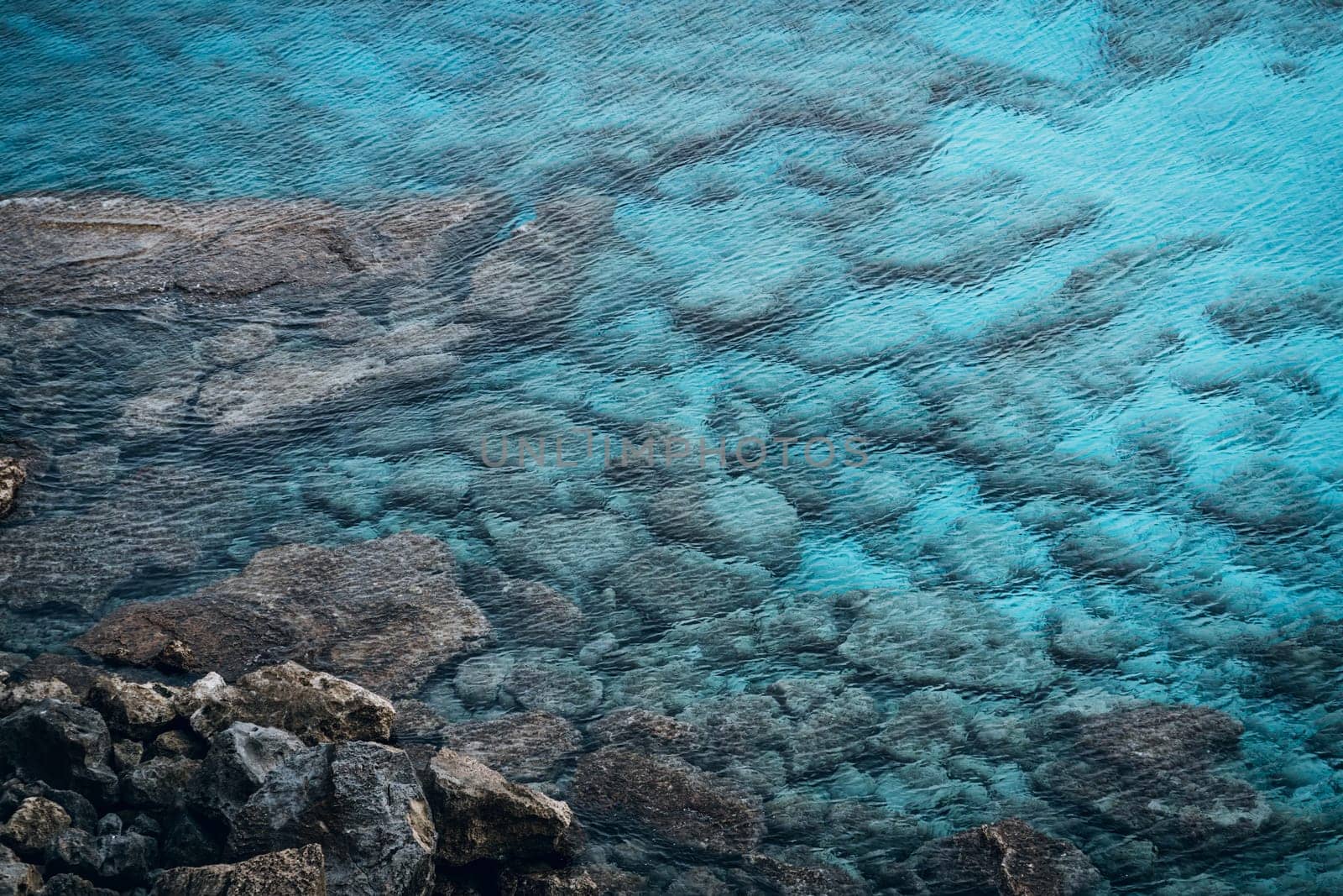 Top view of stones and rocks underwater, rocky sea beach in Cape Greco National Park, Cyprus