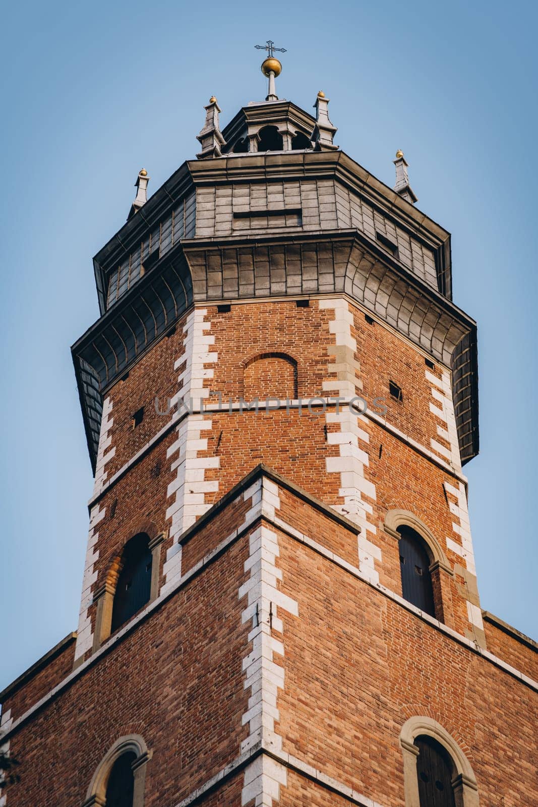 Corpus Christi Basilica brick red tower with arches on windows, Gothic church and landmark in Krakow, Poland