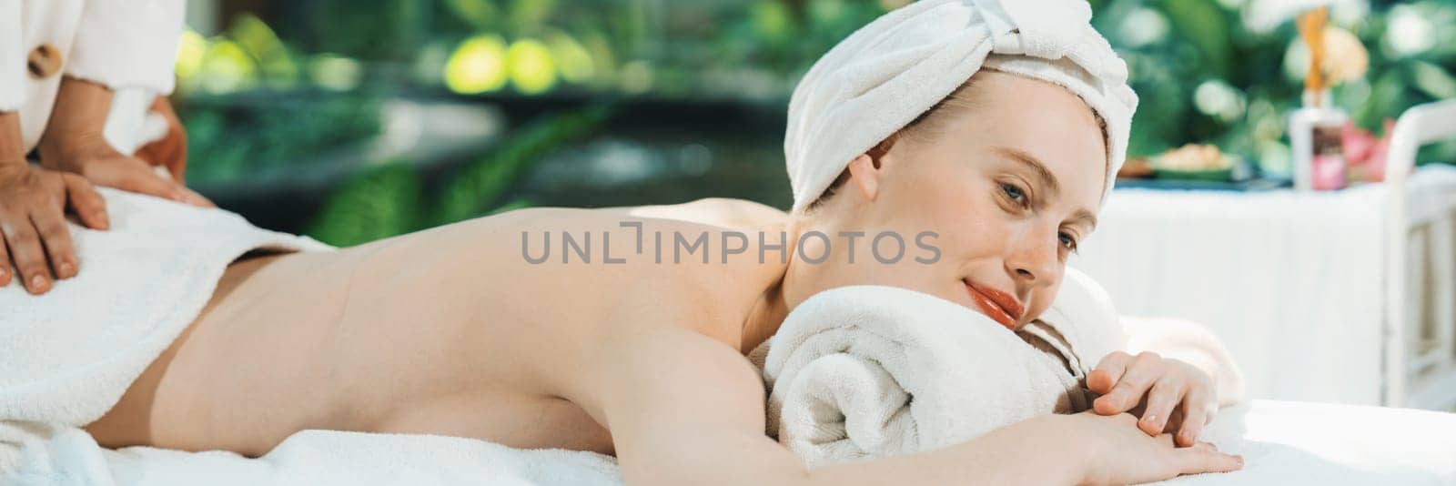 Beautiful relaxing woman having back massage surrounded by nature. Tranquility. by biancoblue