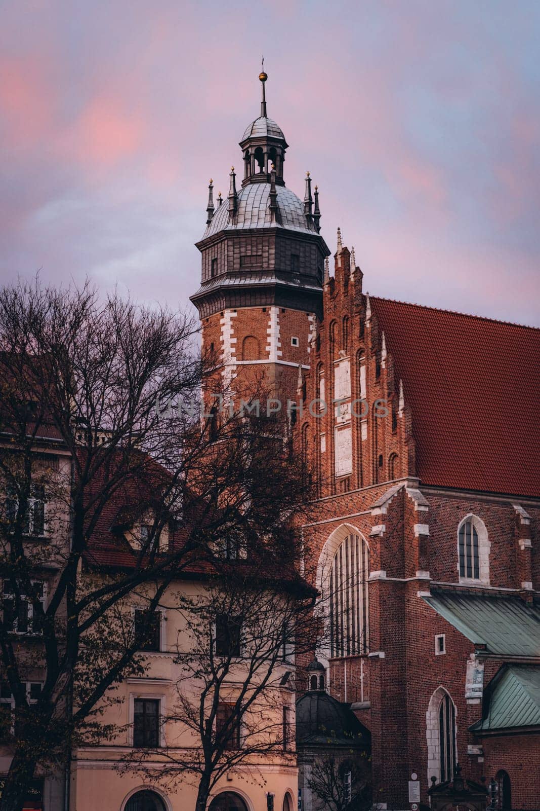 Corpus Christi Basilica and vintage buildings at sunset, Krakow, Poland by Popov